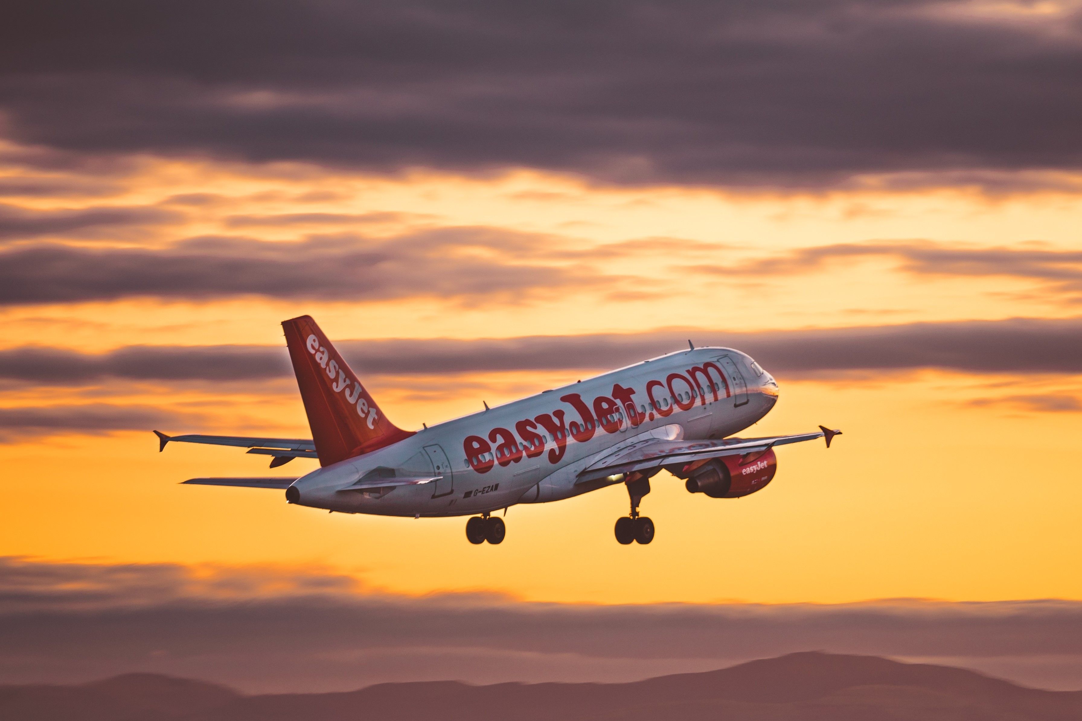 EasyJet Airbus A320 departing Liverpool John Lennon Airport at sunset