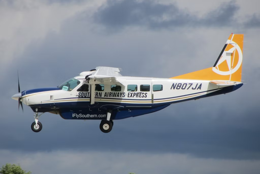A Southern Airways Express Cessna Caravan flying close to the ground.