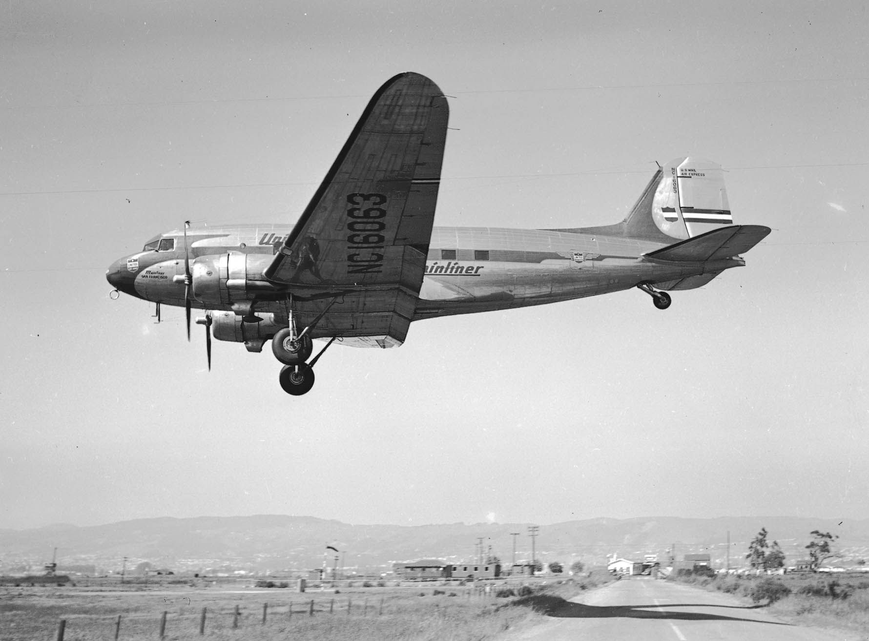 A Douglas DC-3 flying in the sky.