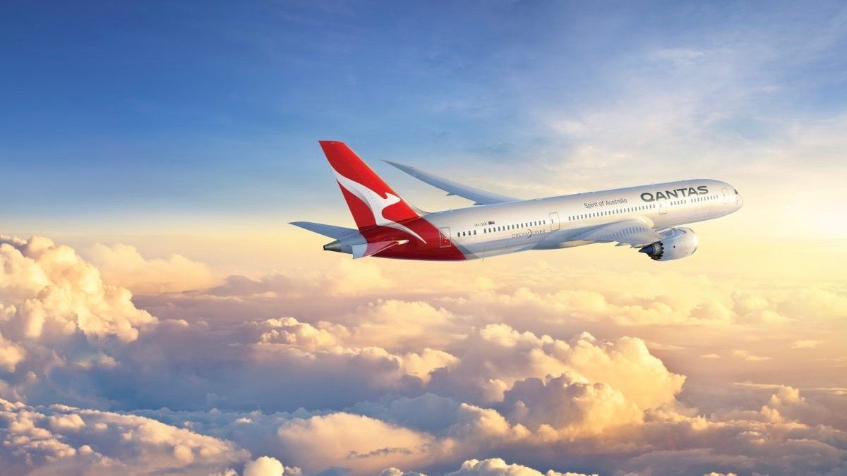 A Qantas Boeing 787 Dreamliner flying above the clouds.