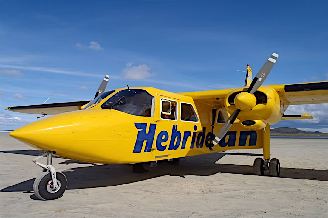 A Hebridean Air Services Islander parked on sand.