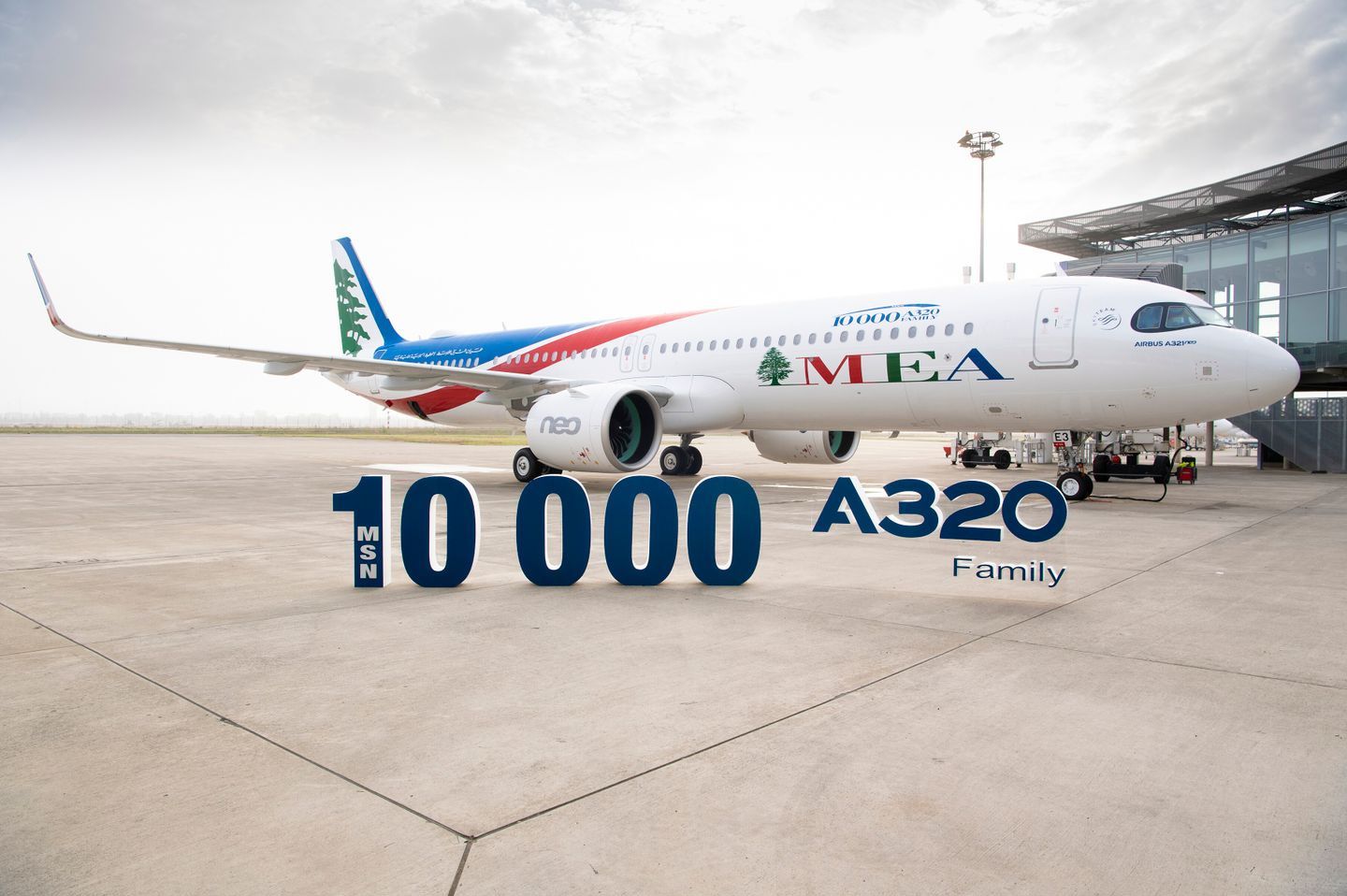 An MEA Airbus A320 at the delivery ceremony, behind a sign denoting the specific example as the 10,000th A320 delivered.