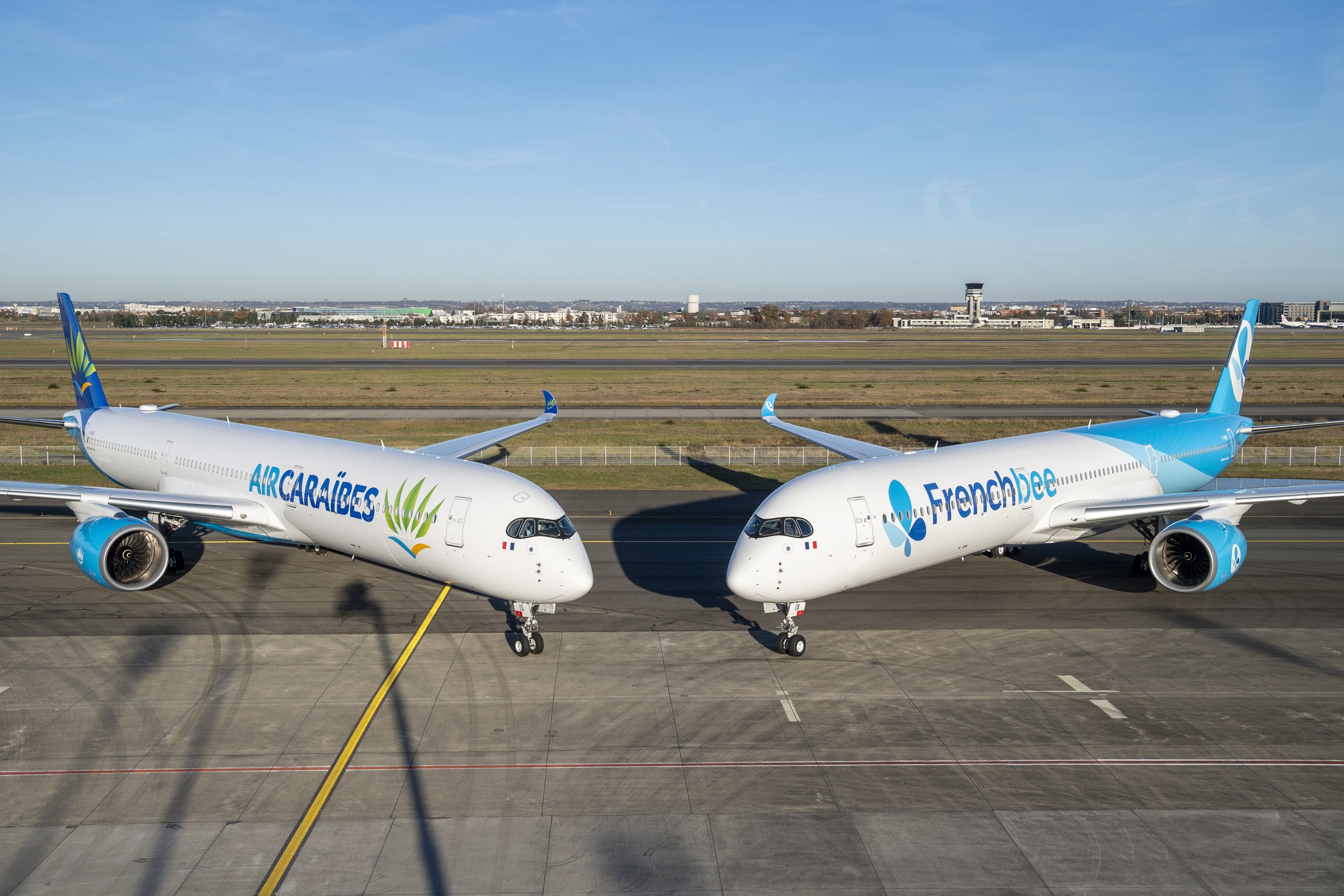 Air Caraibes and French bee Airbus A350-1000s Parked Together.