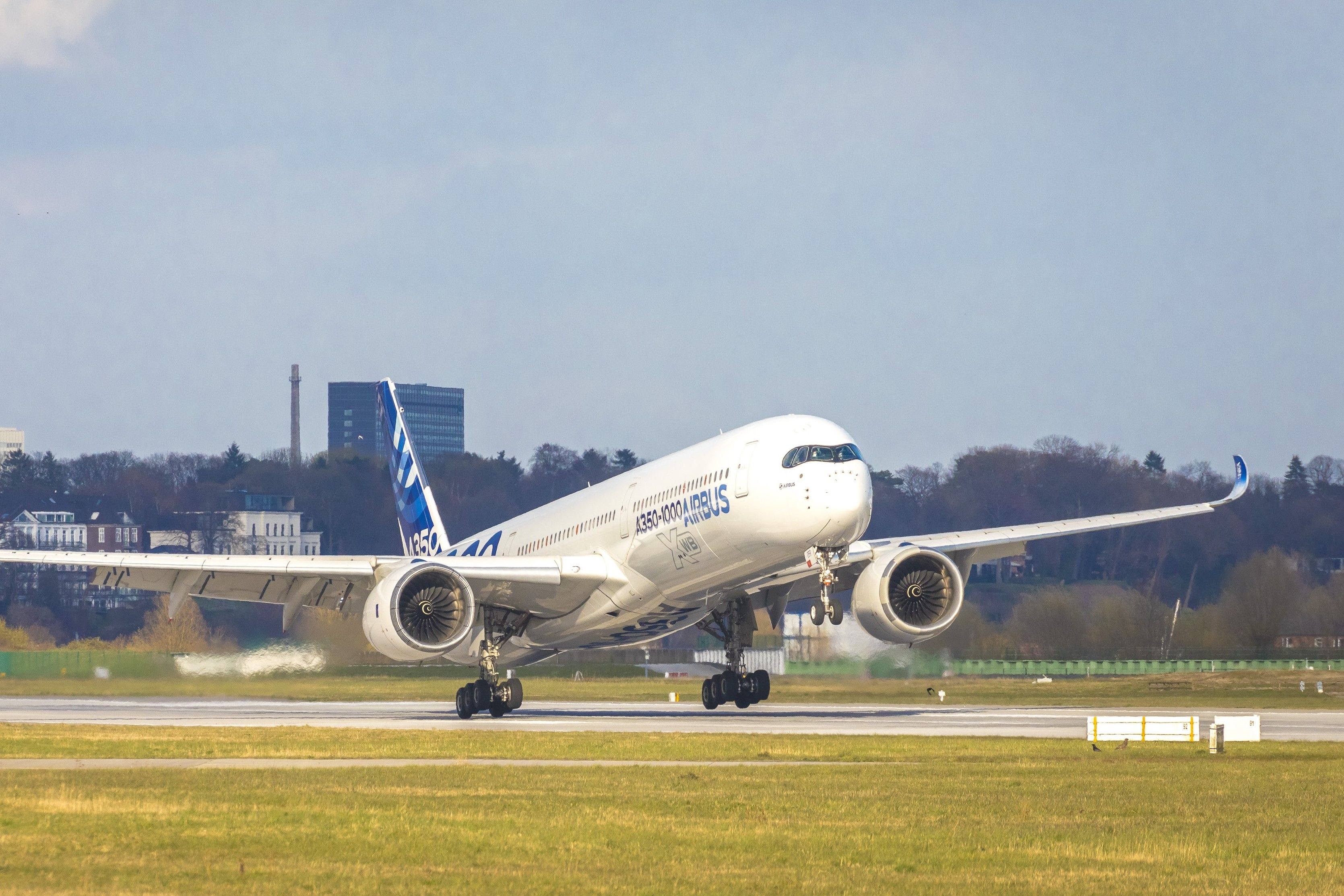 An Airbus A350-1000 landing on a runway.