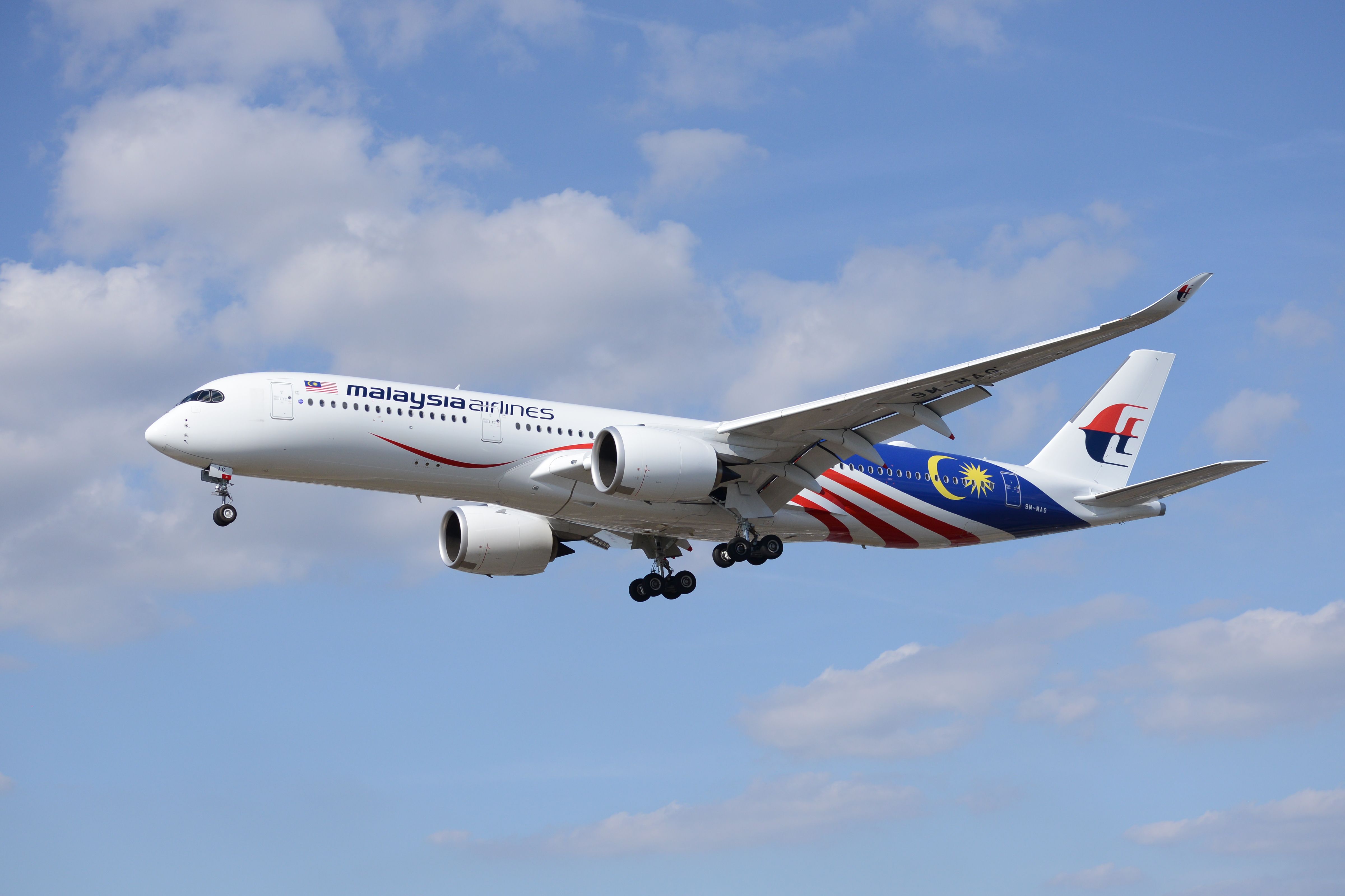 A Malaysia Airlines Airbus A350-900 flying in the sky.