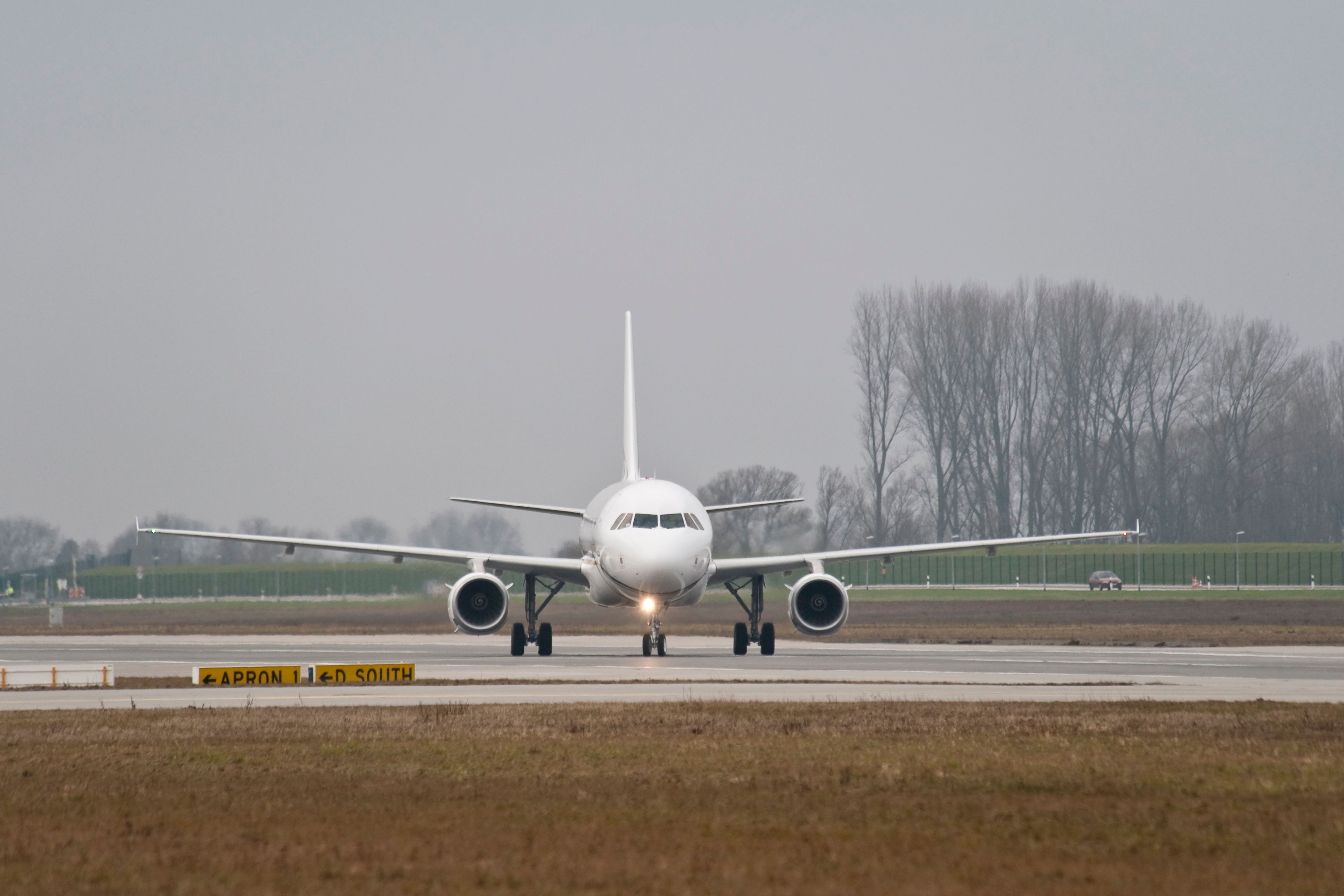 An Airbus A319 Taxiing at an airport.