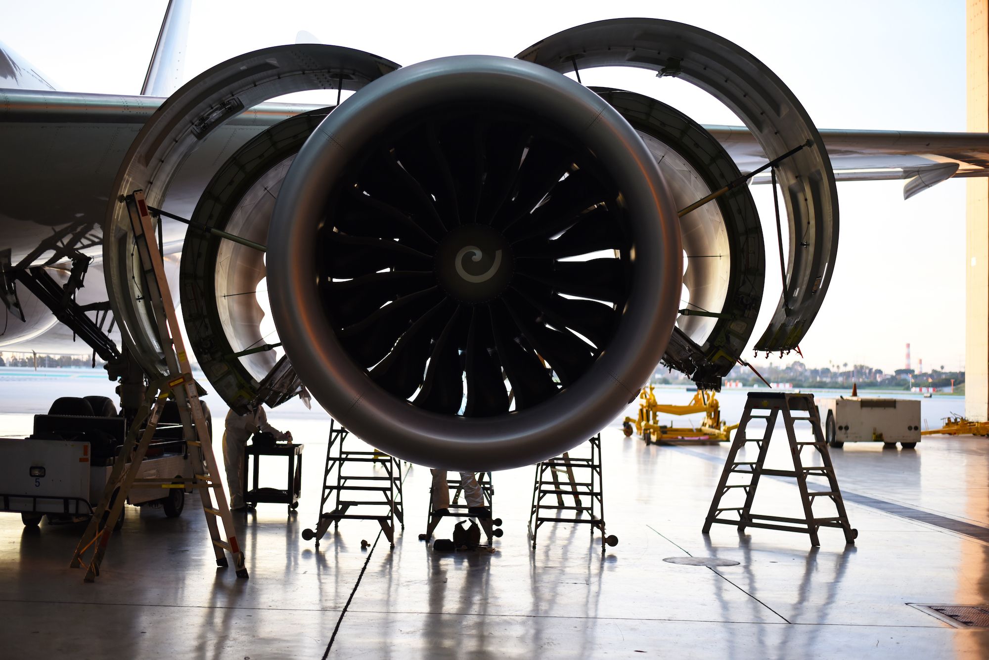 An aircraft engine being opened up for maintenace.