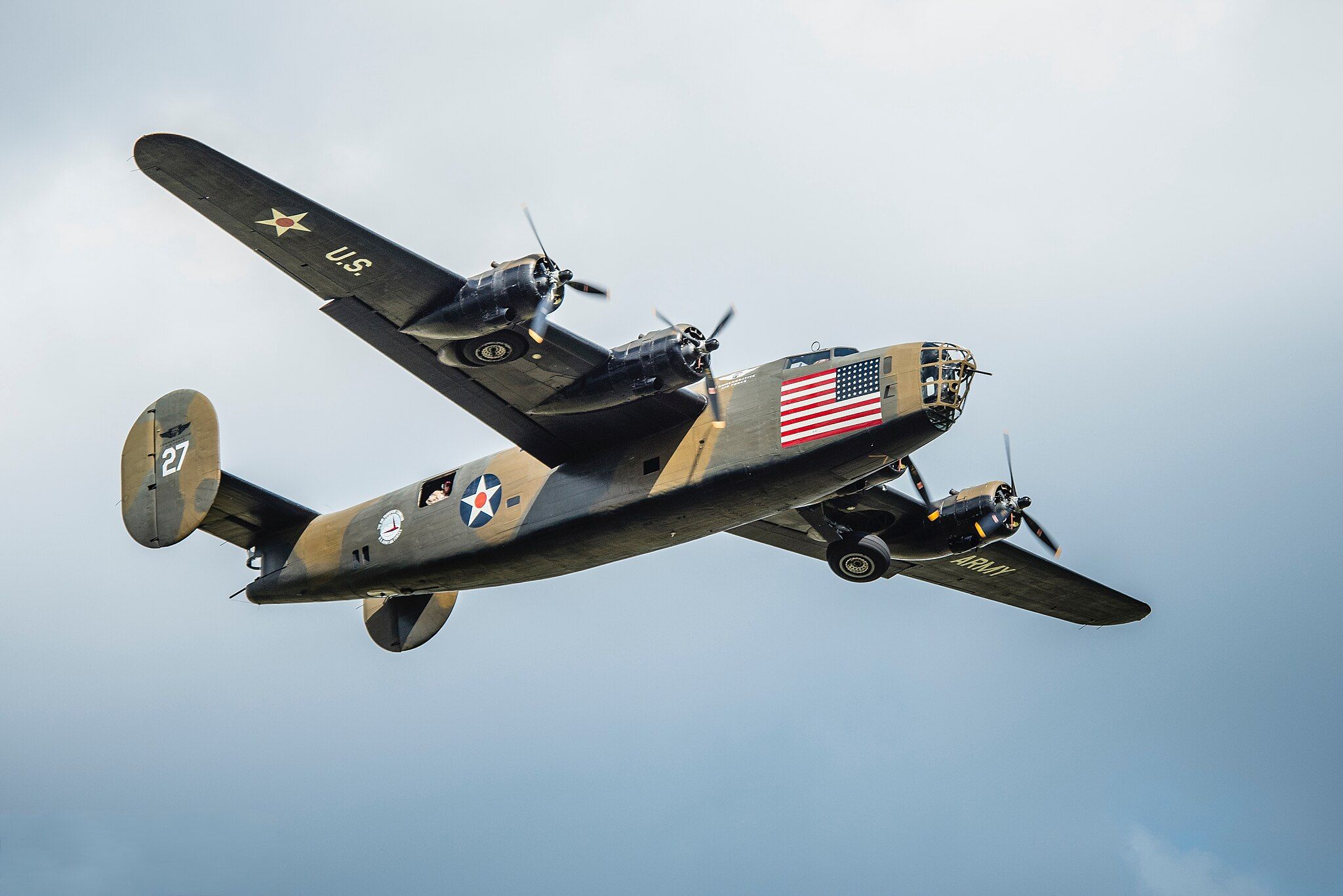 A B-24 Liberator flying in the sky.