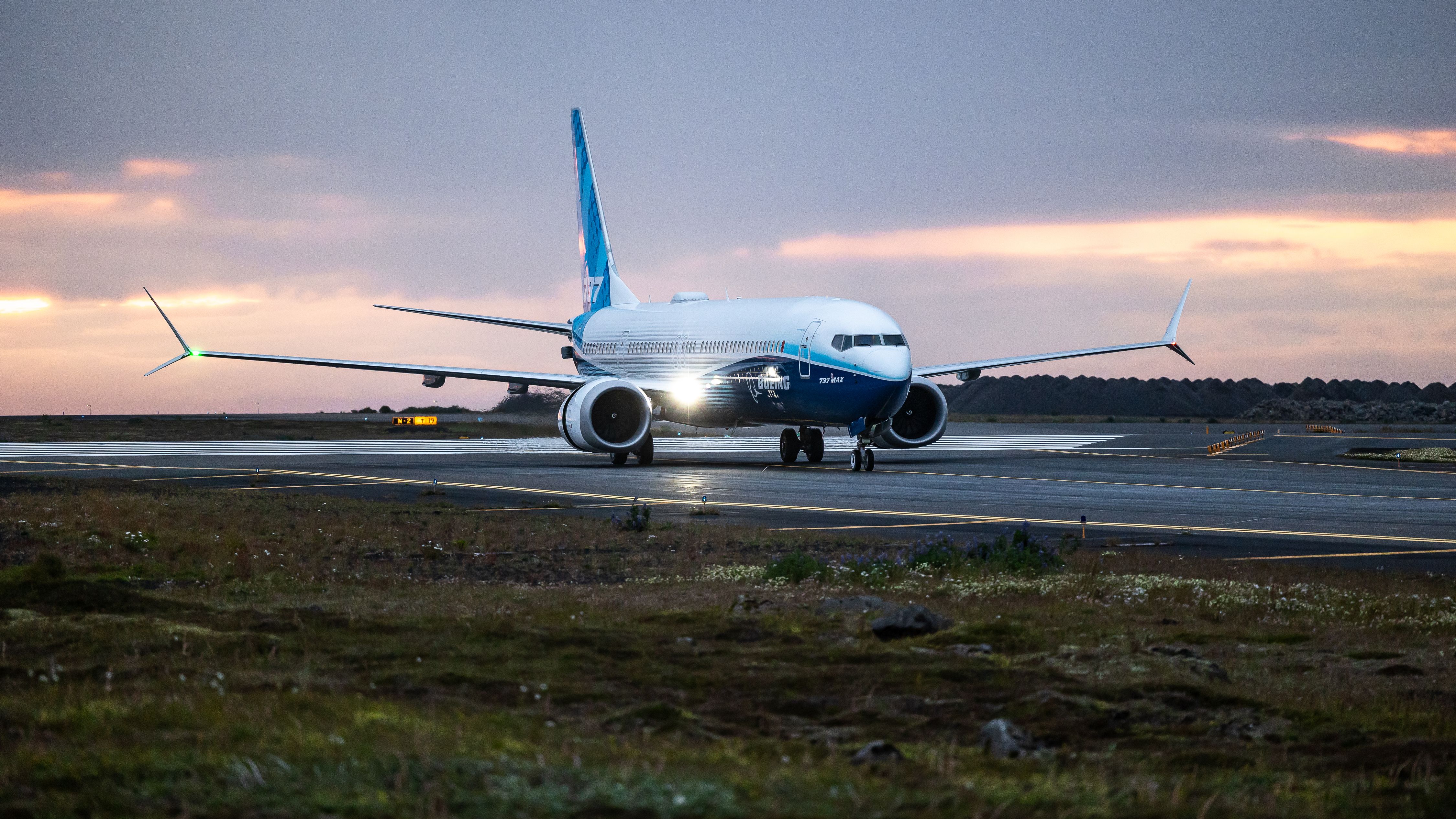 A Boeing 737 MAX 10 landing at sunset