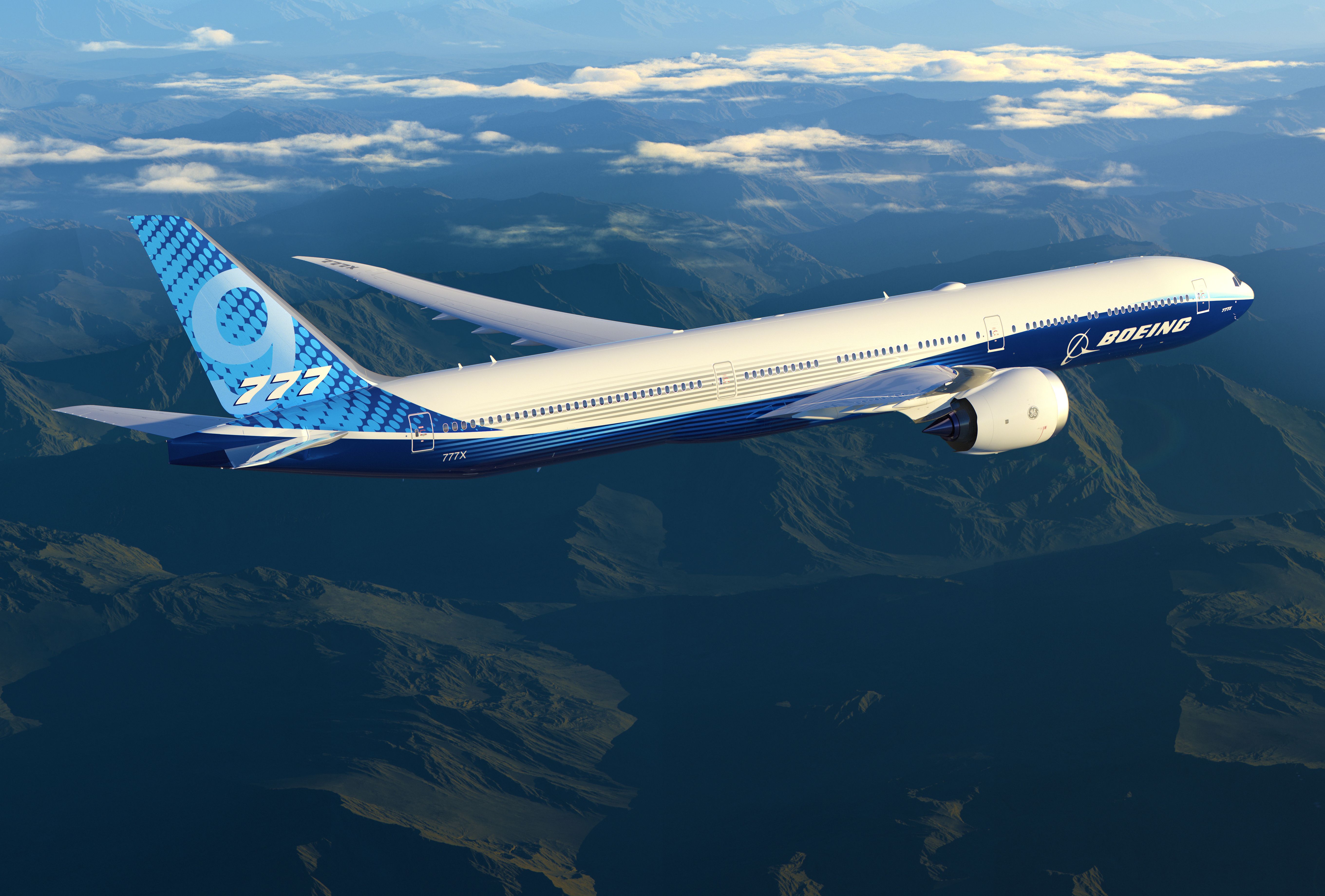 A Boeing 777X in house livery flying in the sky.