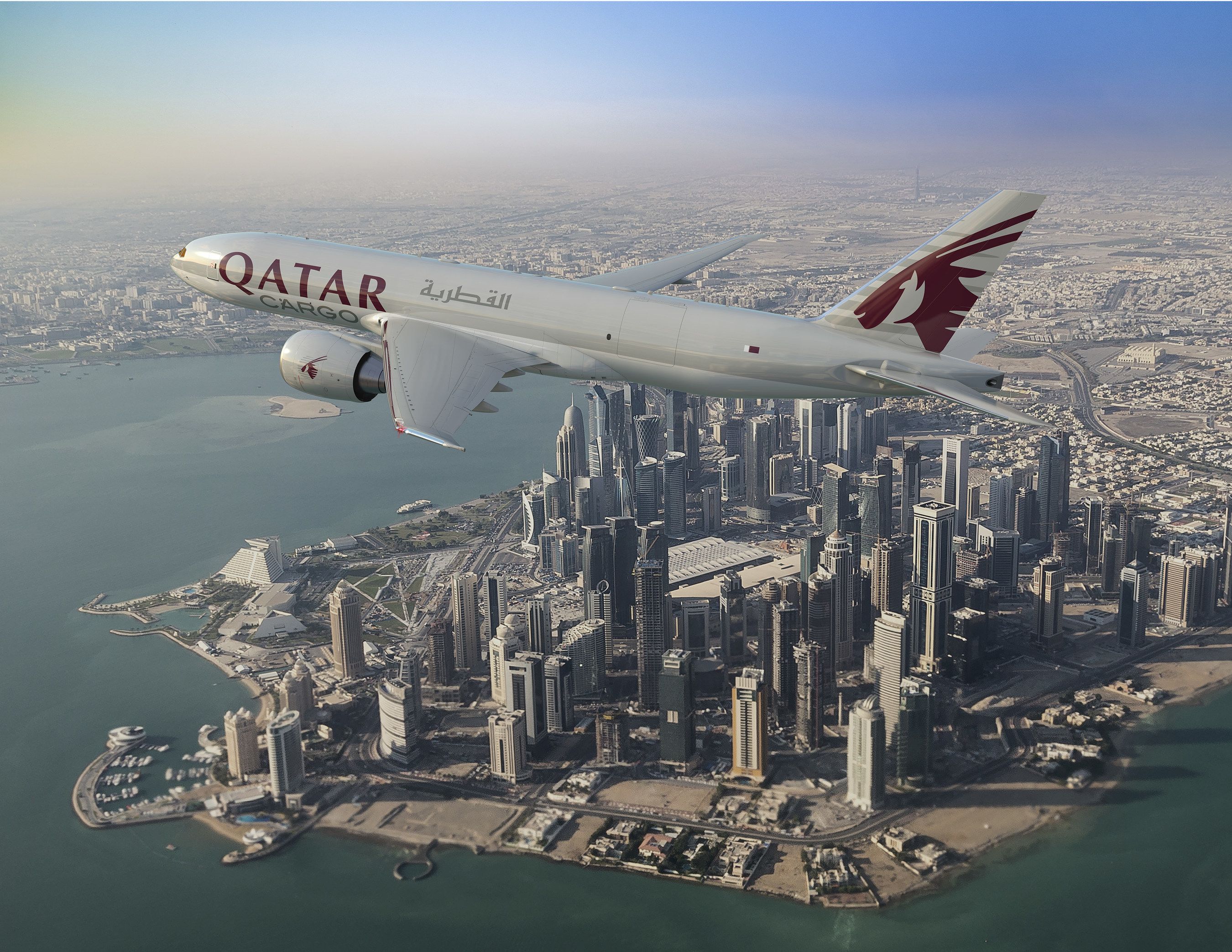 A Qatar Airways 777X frieghter flying over Doha.