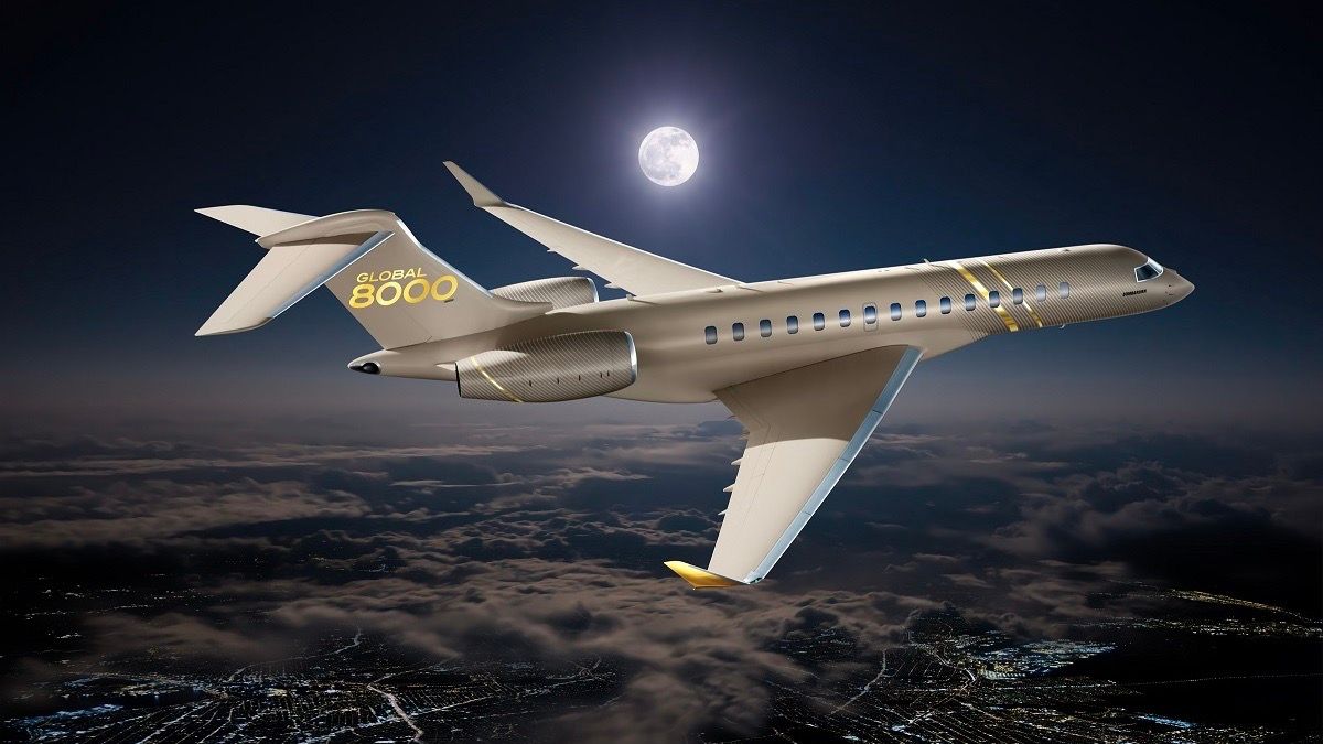 A Bombardier Global 8000 flying over a city at nighttime.