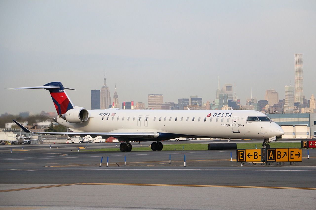 A Delta Air Lines Bombardier CRJ900 on a taxiway.