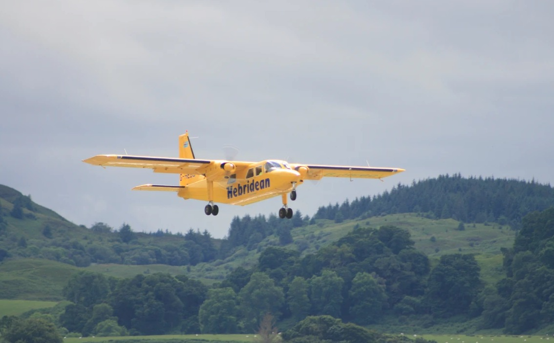 A Hebridean Air Services Islander flying in the sky.