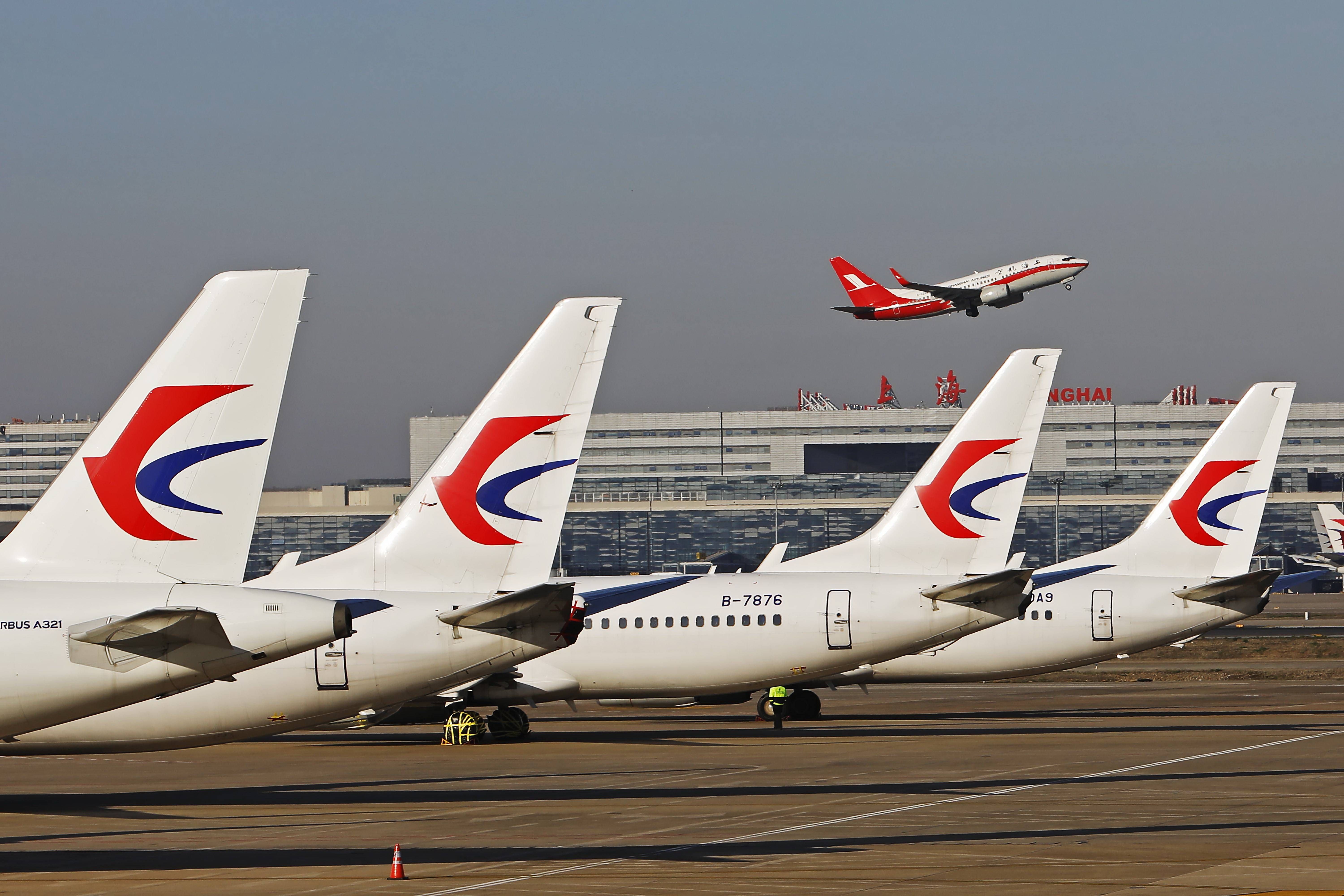 Several China Eastern Aircraft parked on an airport apron.