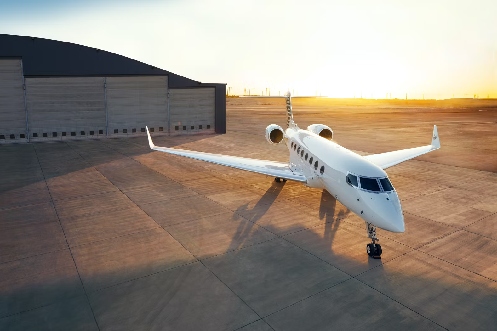 A Qatar Executive Gulfstream G650ER Aircraft parked outside of a hangar.