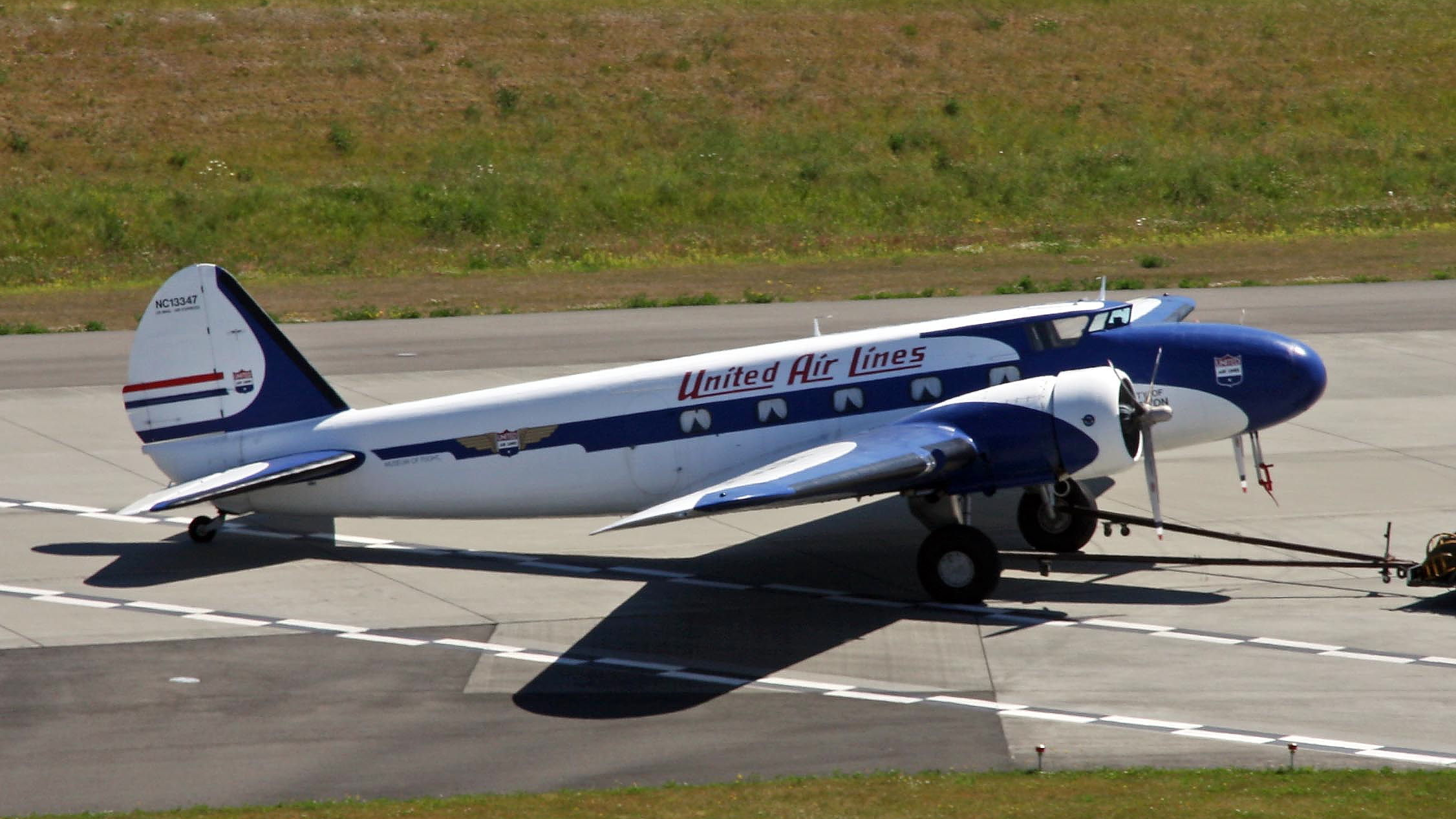 A United Air Lines Boeing 247 parked at an airfield.