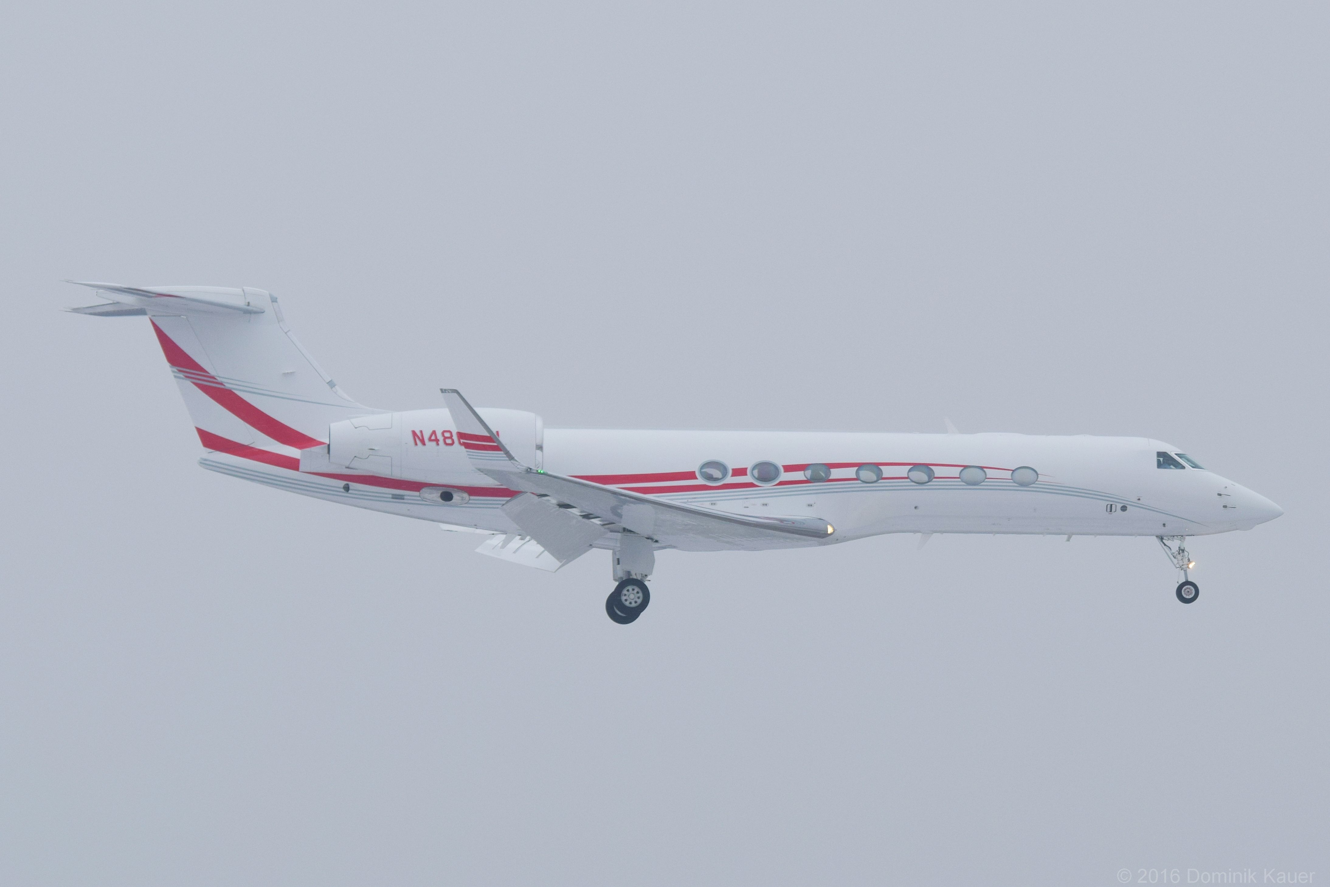 A Coca-Cola Gulfstream G550 flying in the clouds.