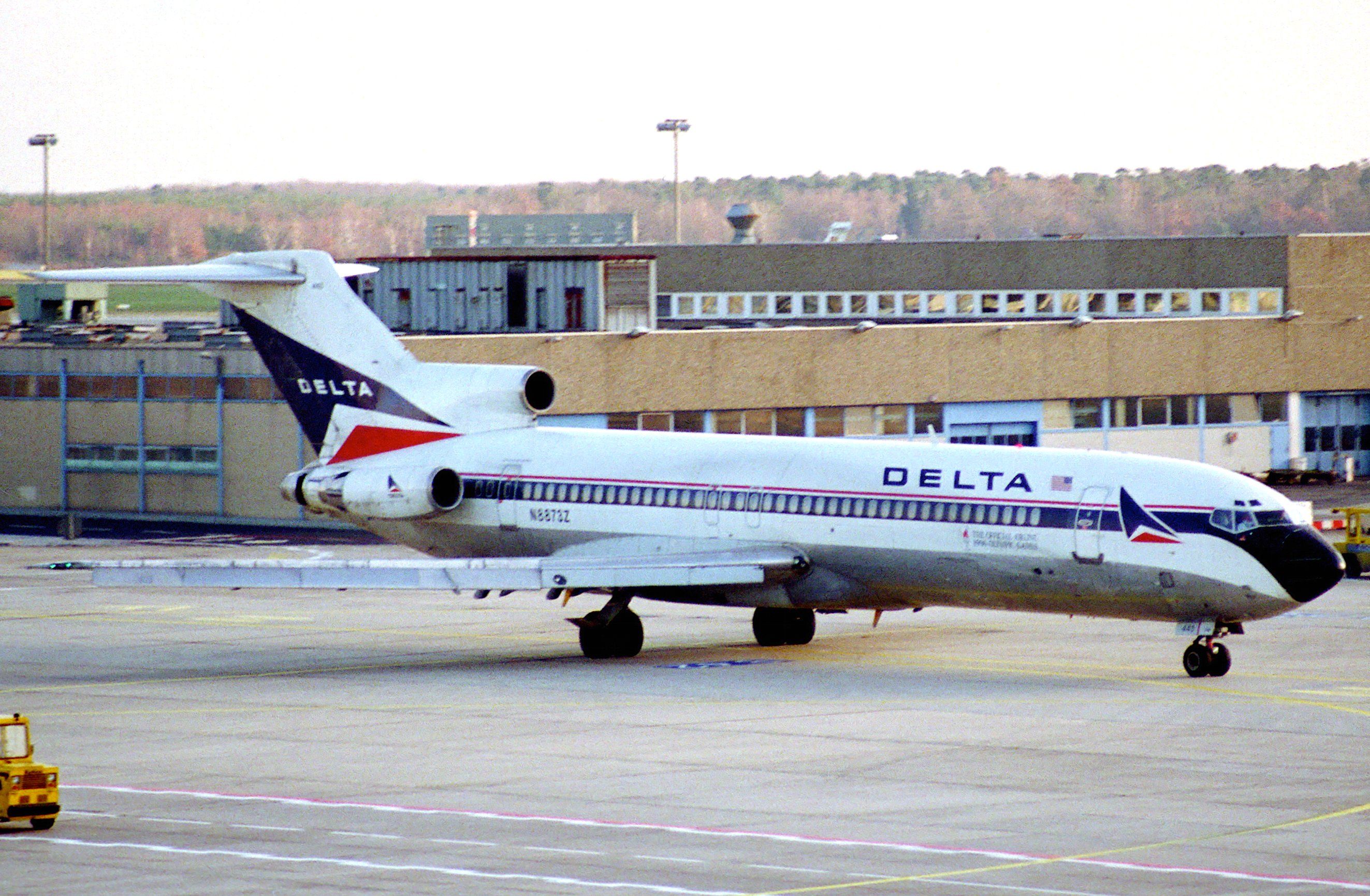 A Delta Air Lines Boeing 727 parked at an airport.