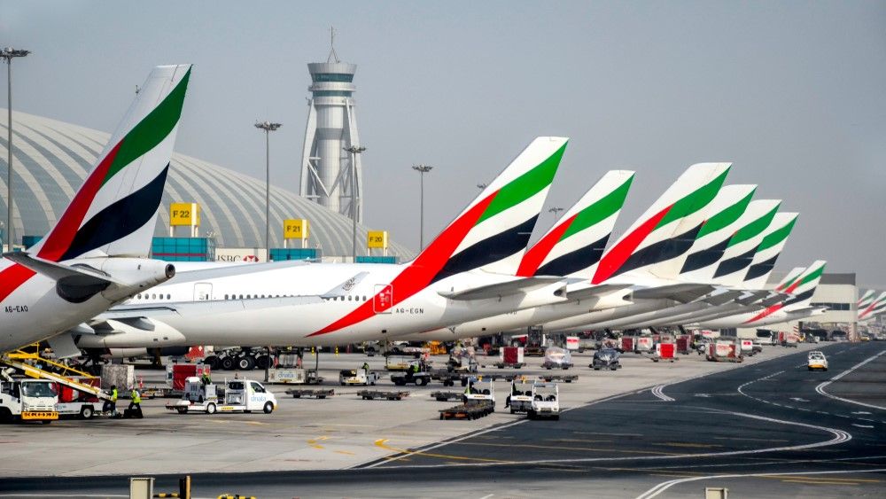 Several Emirates Widebody aircraft parked at Dubai International Airport.