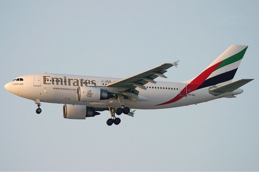 An Emirates Airbus A310-300 flying in the sky.