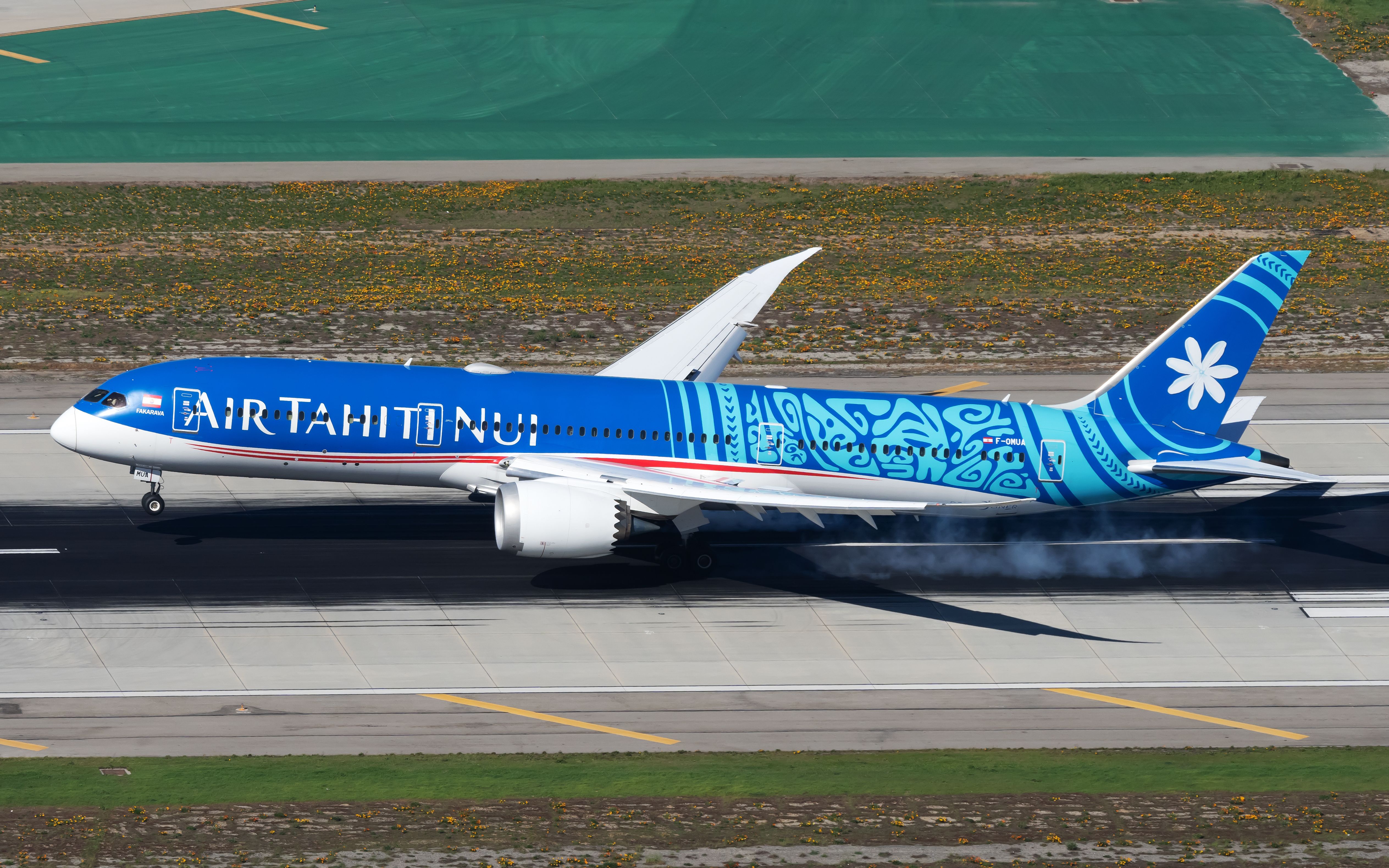 An Air Tahiti Nui Boeing 787-9 Dreamliner landing at an airport.