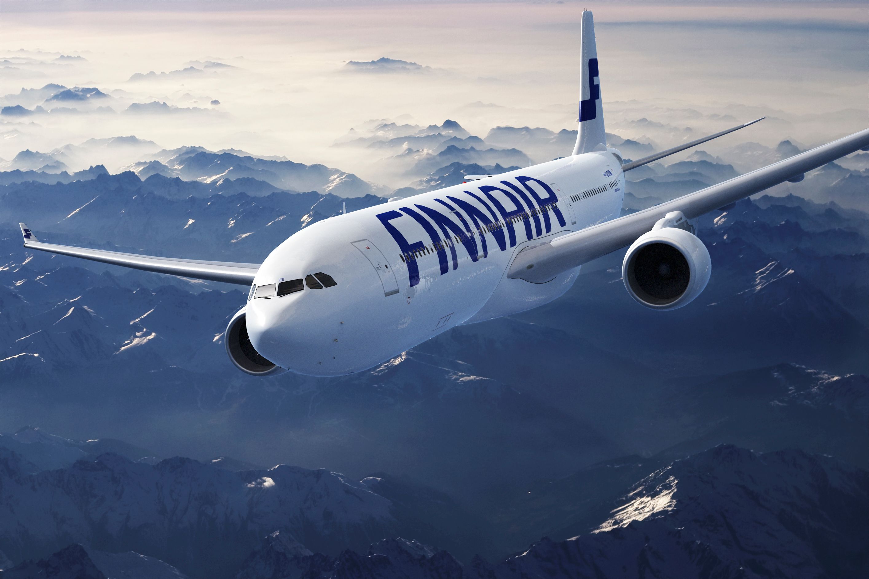 A Finnair Airbus A330 flying over mountainous terrain.