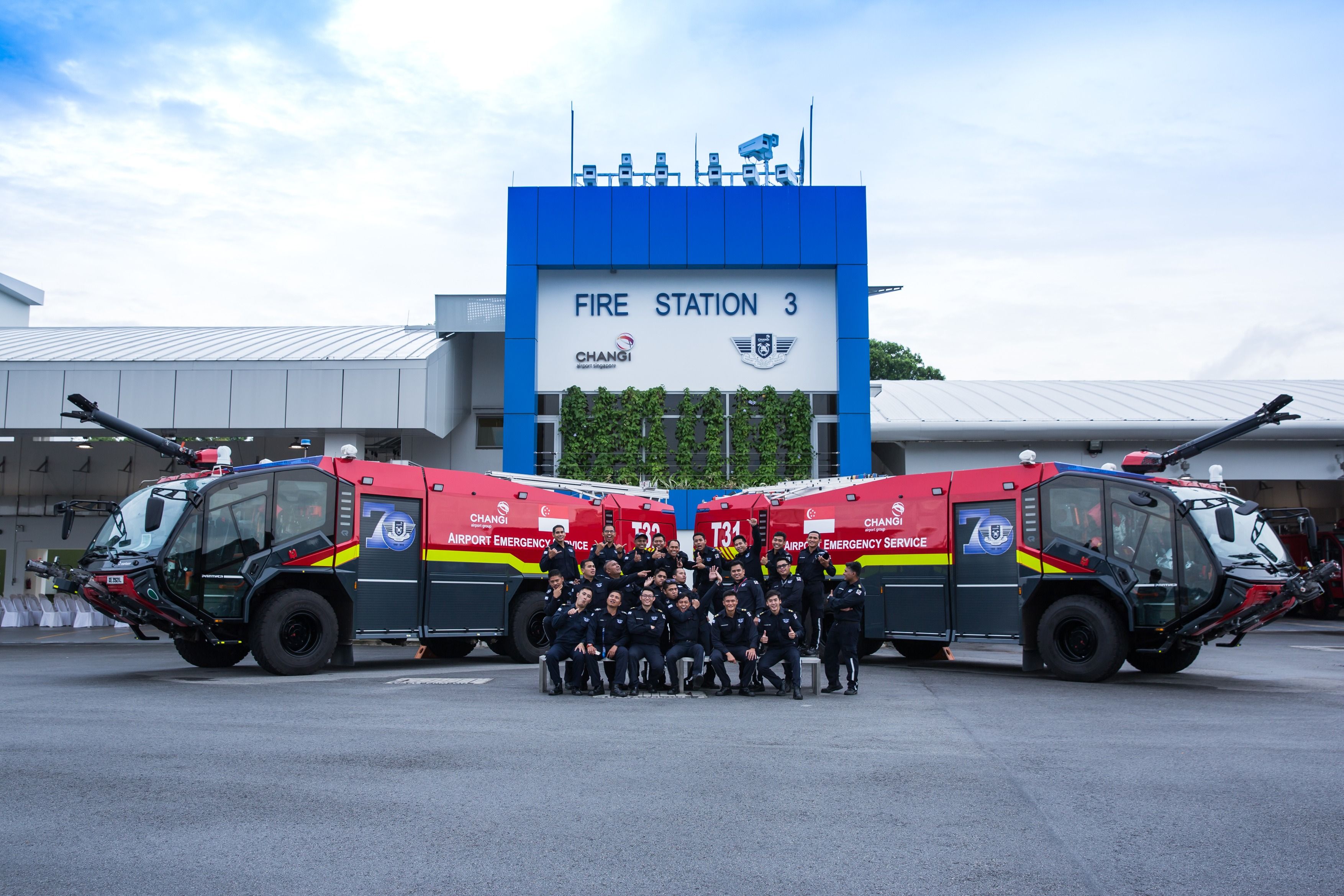 Fire Trucks and Firefighters outside the Fire Station at Singapore Changi Airport.