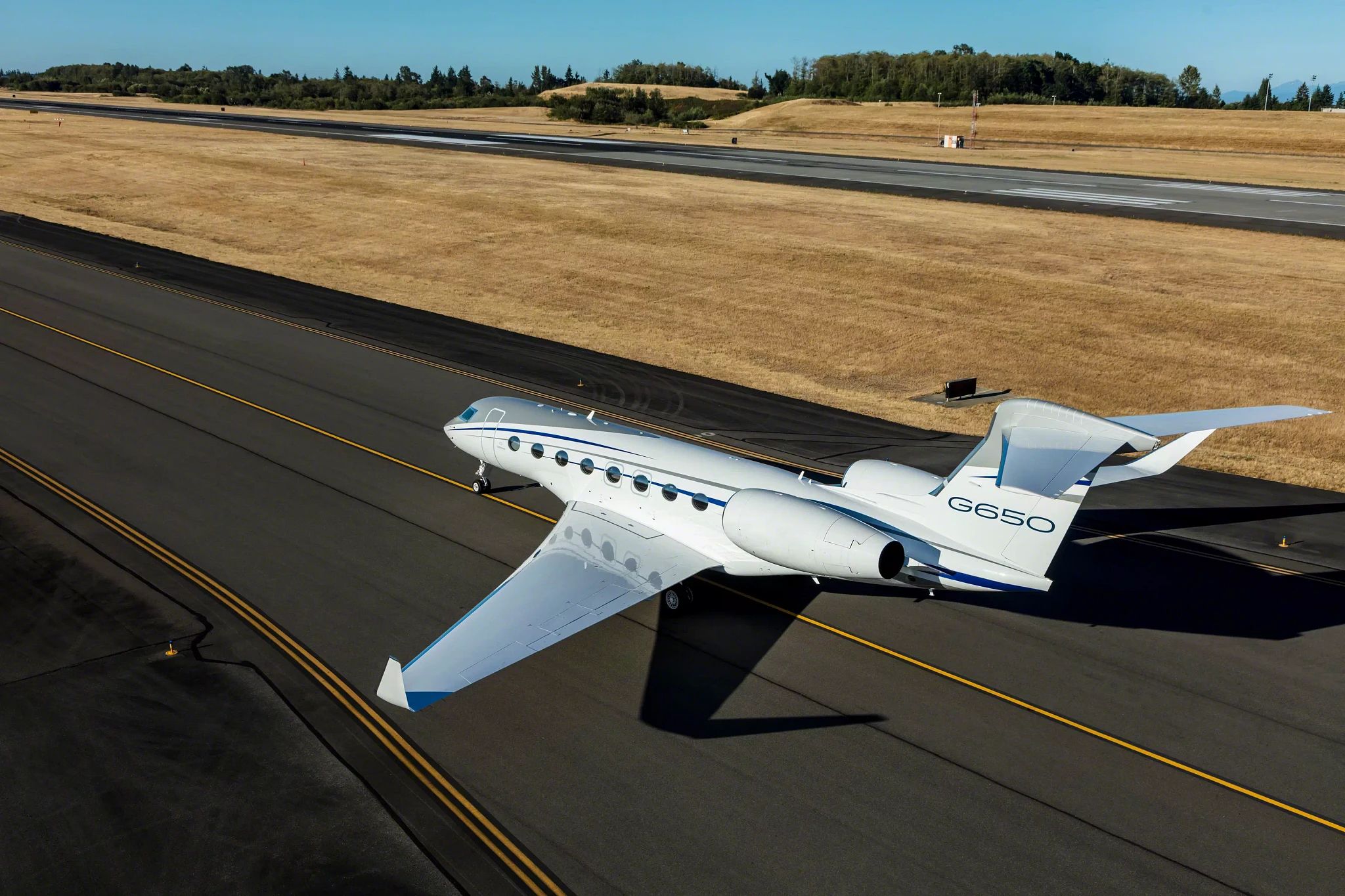 A Gulfstream G650 lined up on a runway.