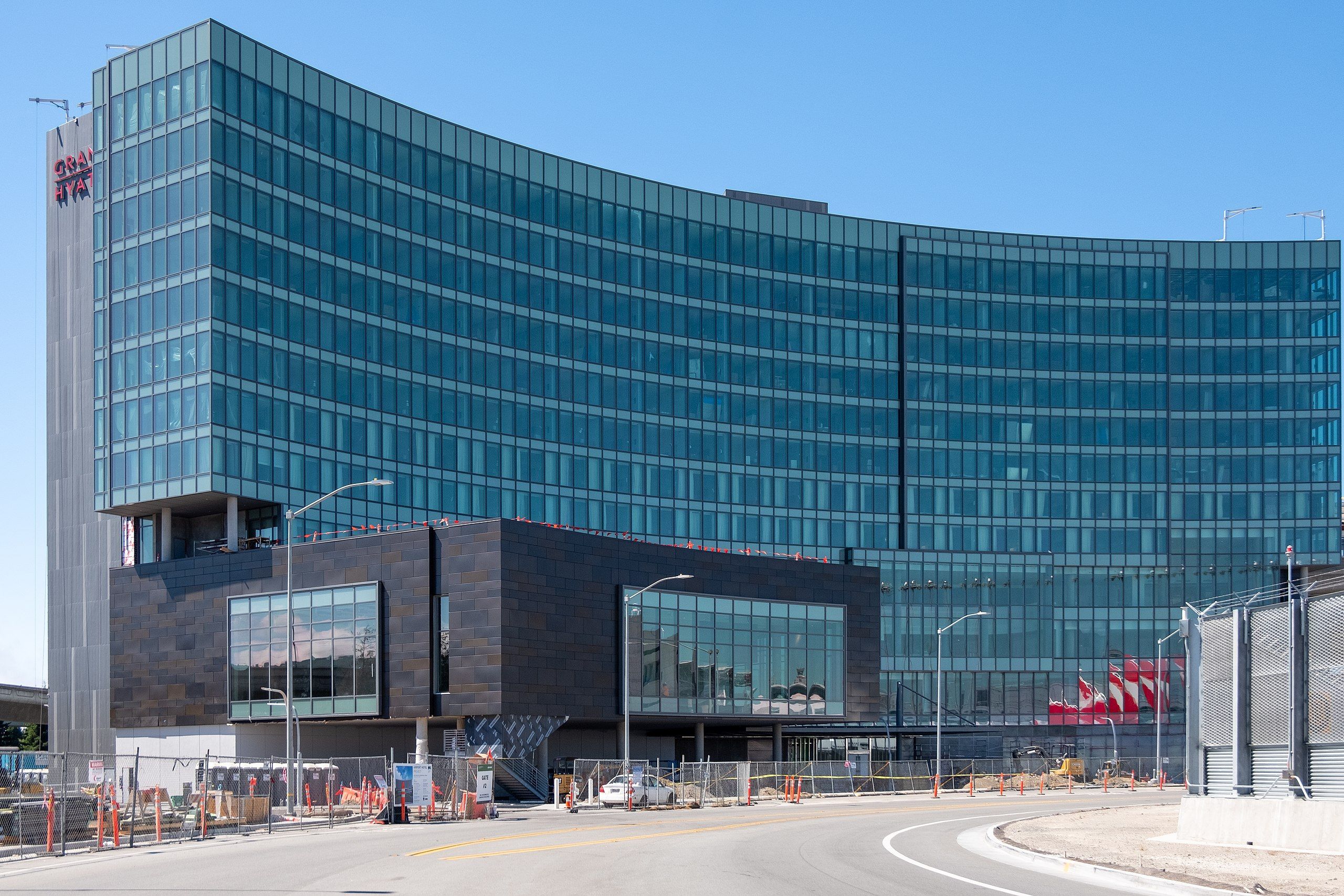Curved glass structure with roadway running in front- new Harvey Milk Terminal 1