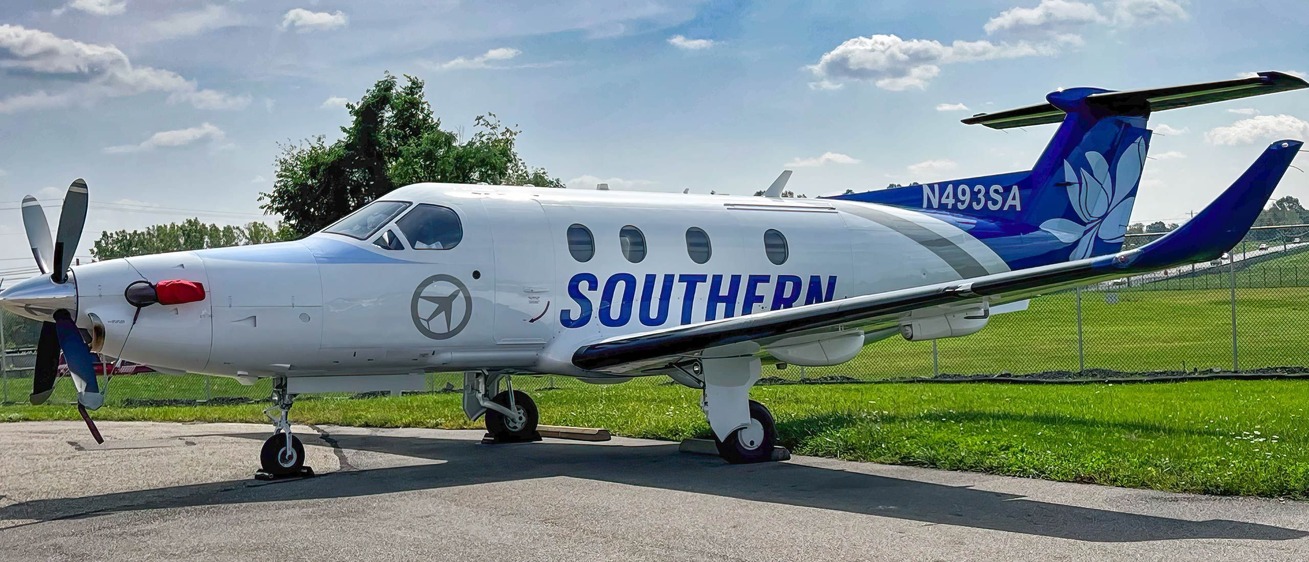 A Southern Airways Express Pilatus PC-12 parked at an airport.