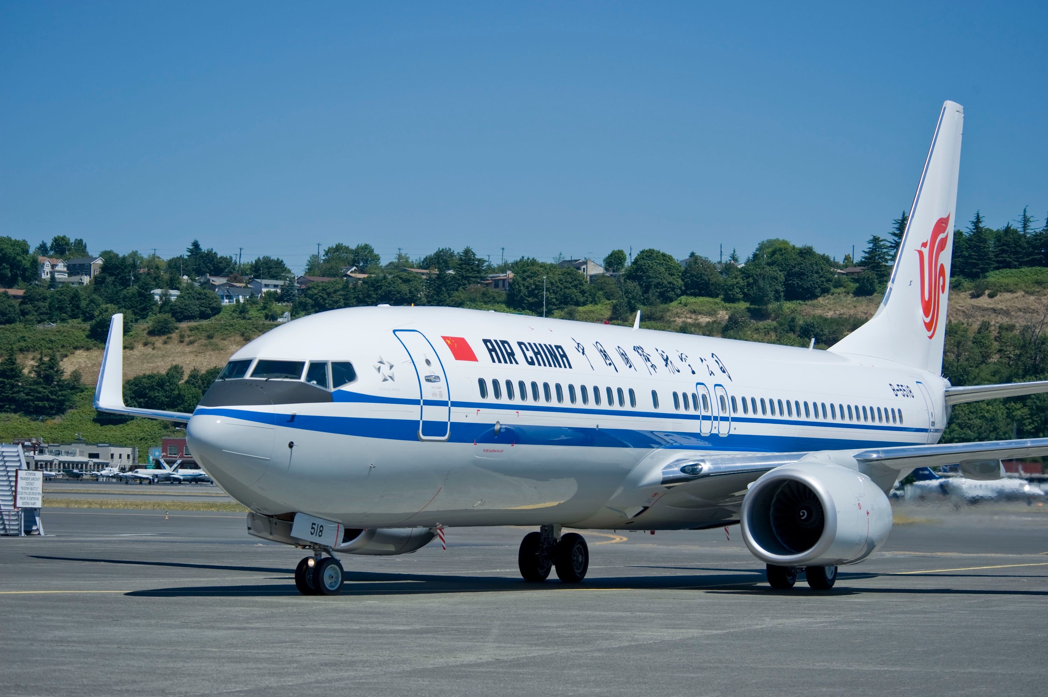 An Air China Boeing 737-800 Parked at an airport In Sunny Conditions.