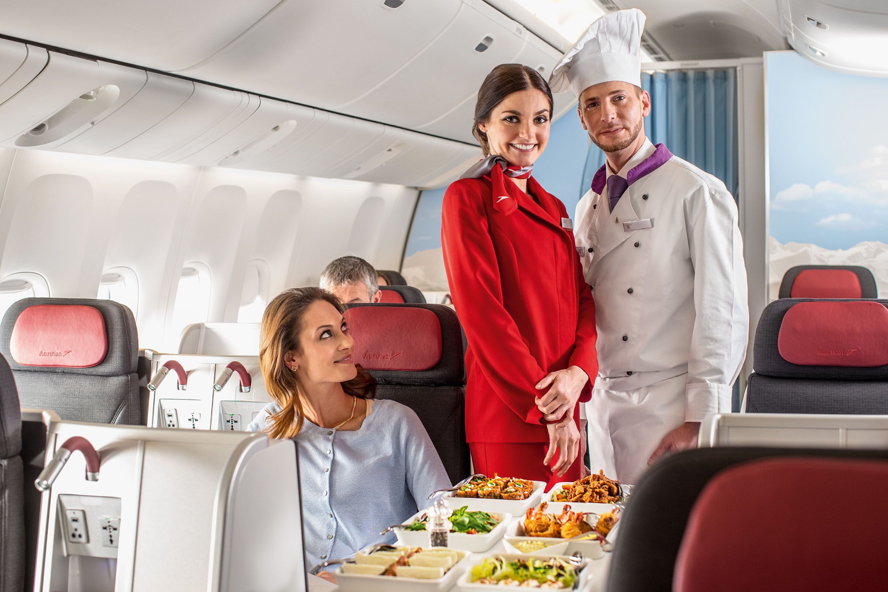 An Austrian Airlines flight attnedant standing next to the onboard chef.
