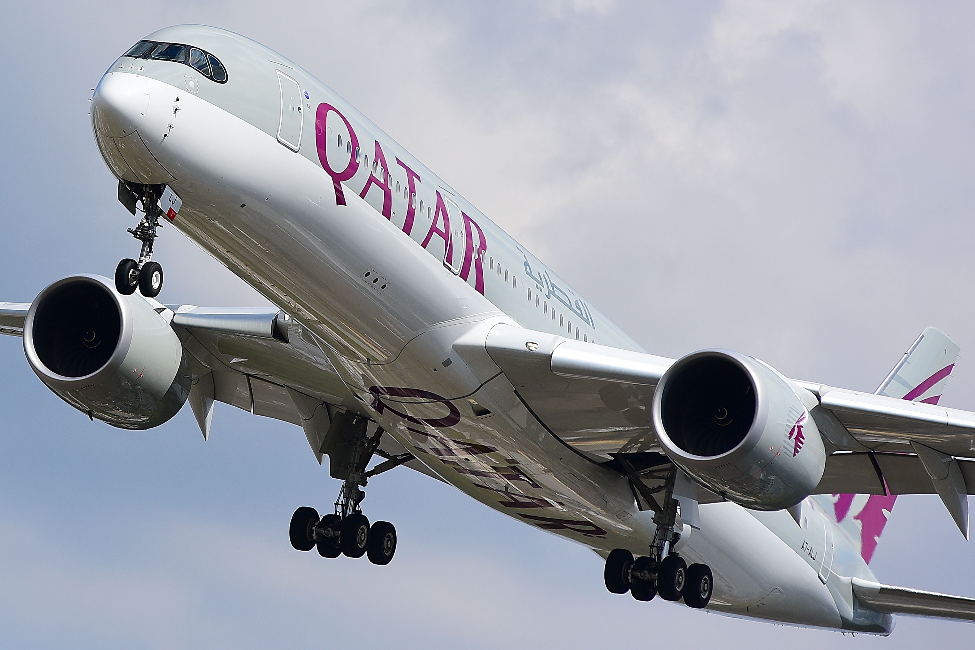 A Qatar Airways Airbus A350-900 flying in the sky.