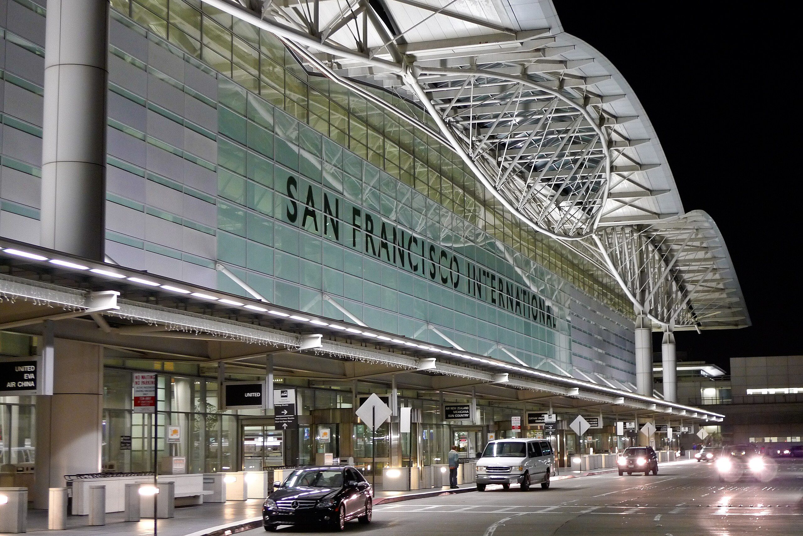 Nighttime photo of the aluminum and glass international terminal at San Francisco International Airport