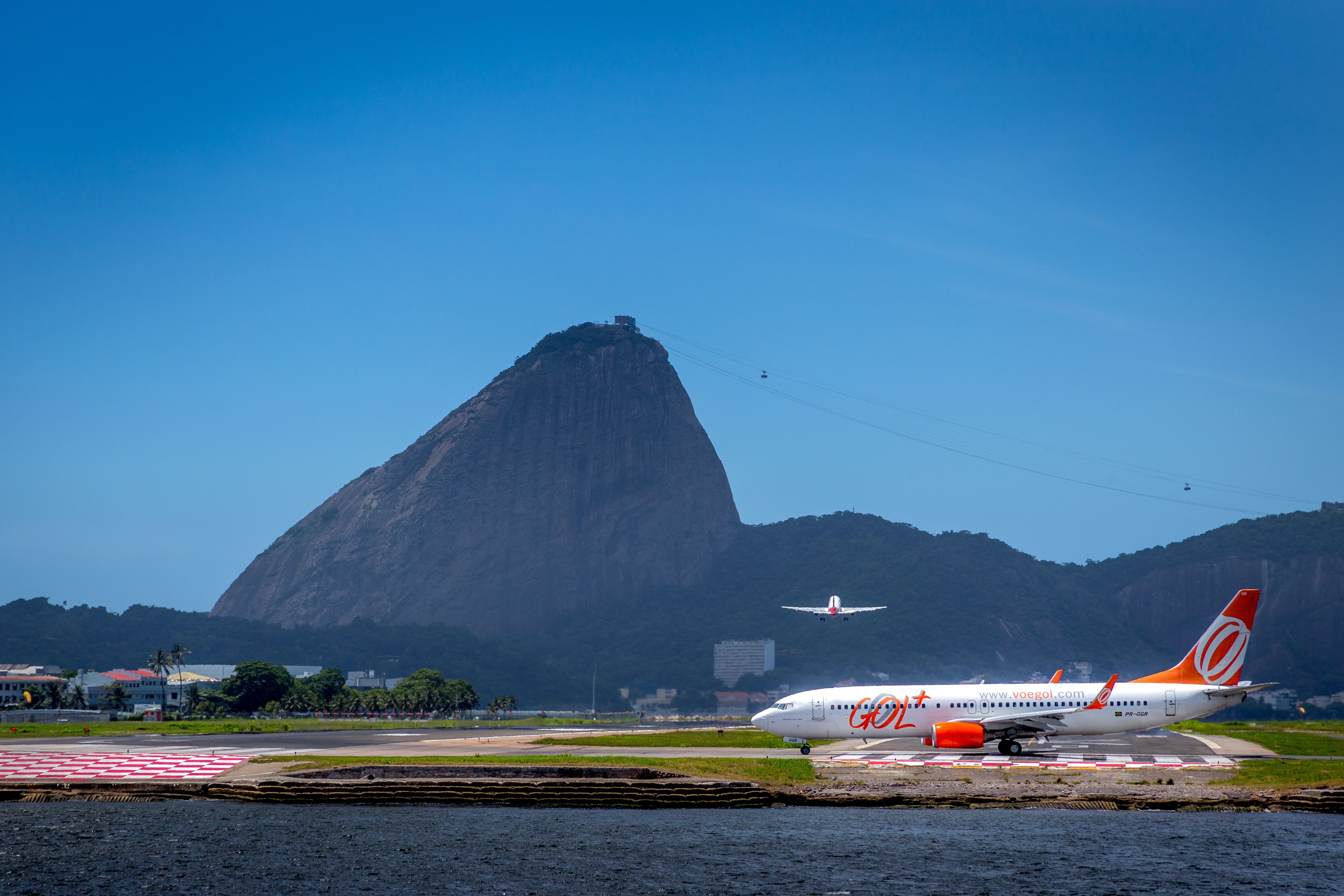 A GOL airplane at Rio de Janeiro Brazil Santos Dumont Airport runway, overlooking the Sugar Loaf.