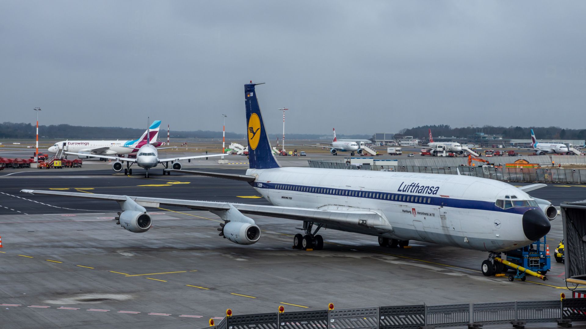 A Lufthansa Boeing 707 parked at an airport.