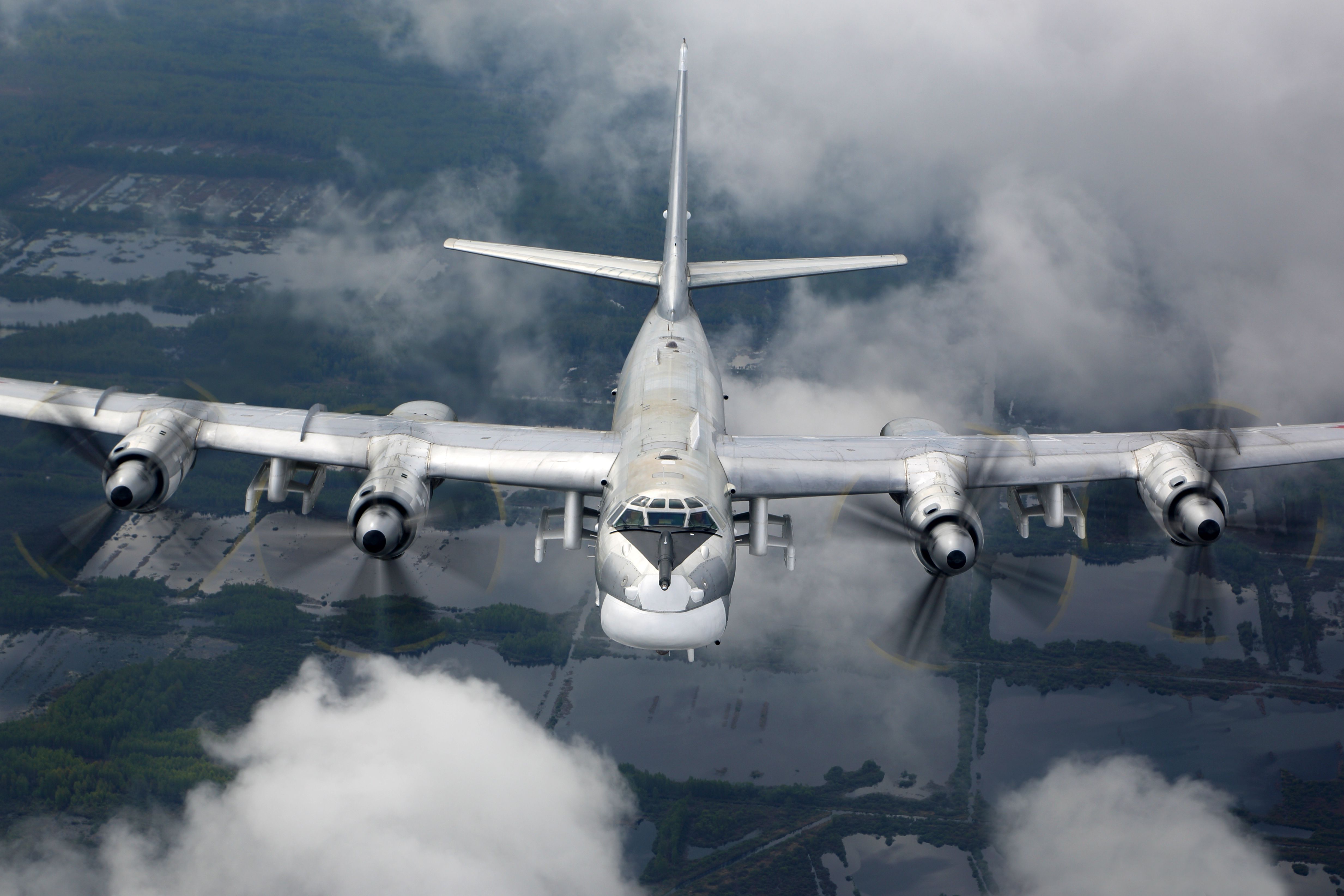 A left underside view of a Soviet Tu-95 Bear D aircraft in flight