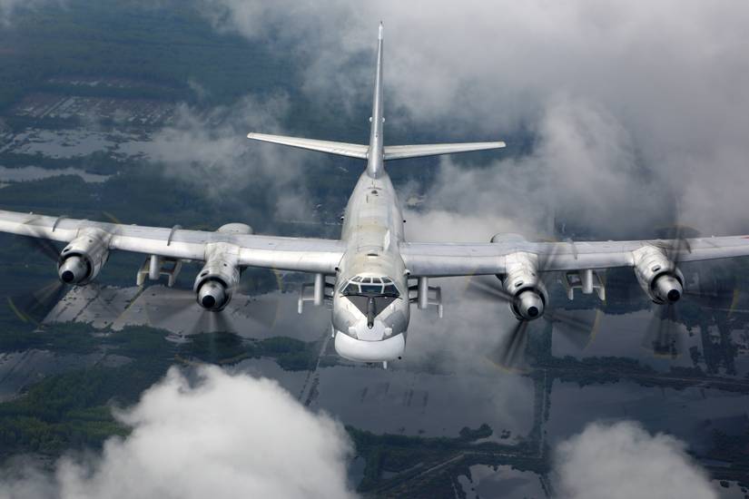 A Tupolev Tu-95 flying in the sky.