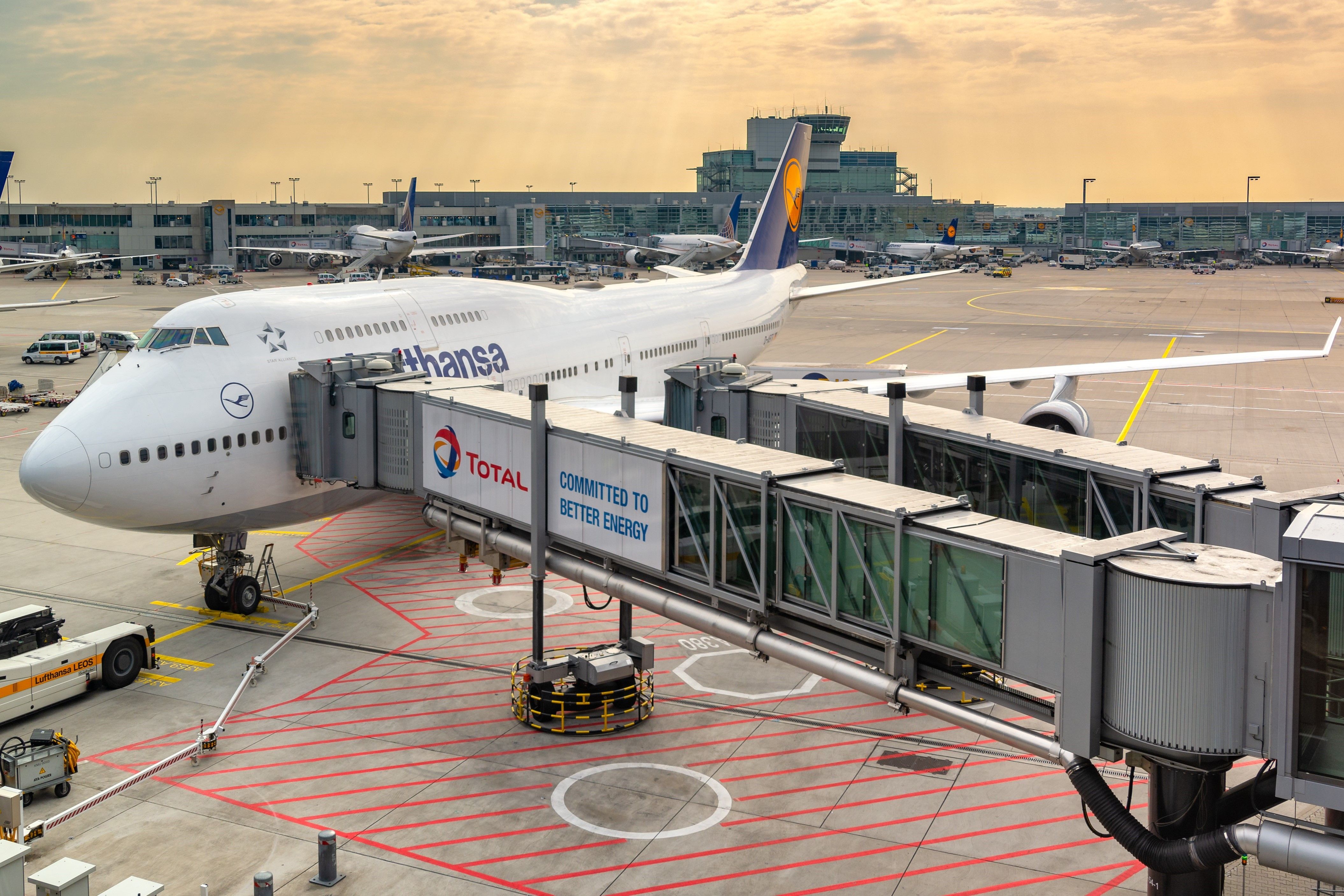 A Lufthansa Boeing 747 parked at a gate.