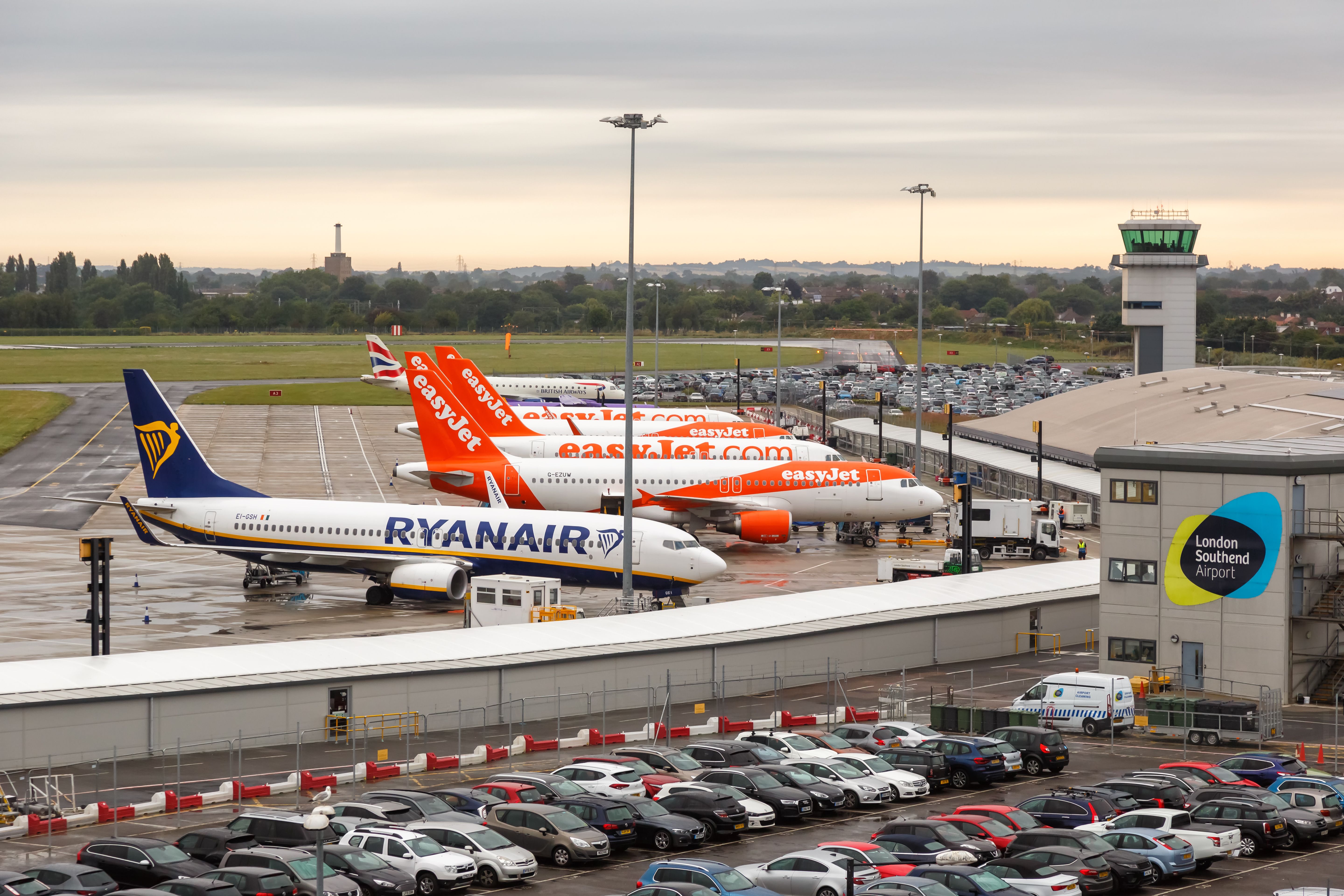 Several easyJet aircraft parked next to a British Airways and Ryanair jet at London Southend Airport.