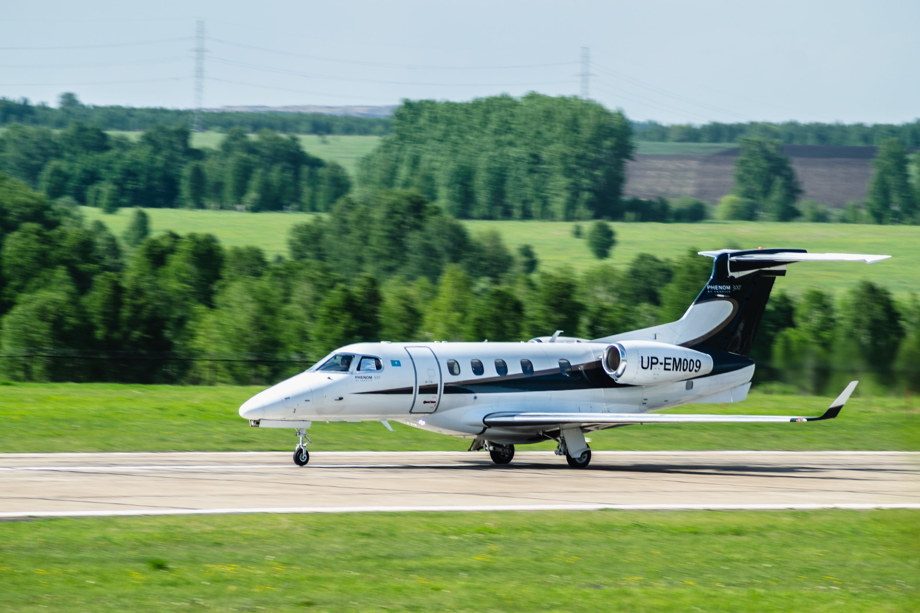 An Embraer Phenom 300 on an airport apron.