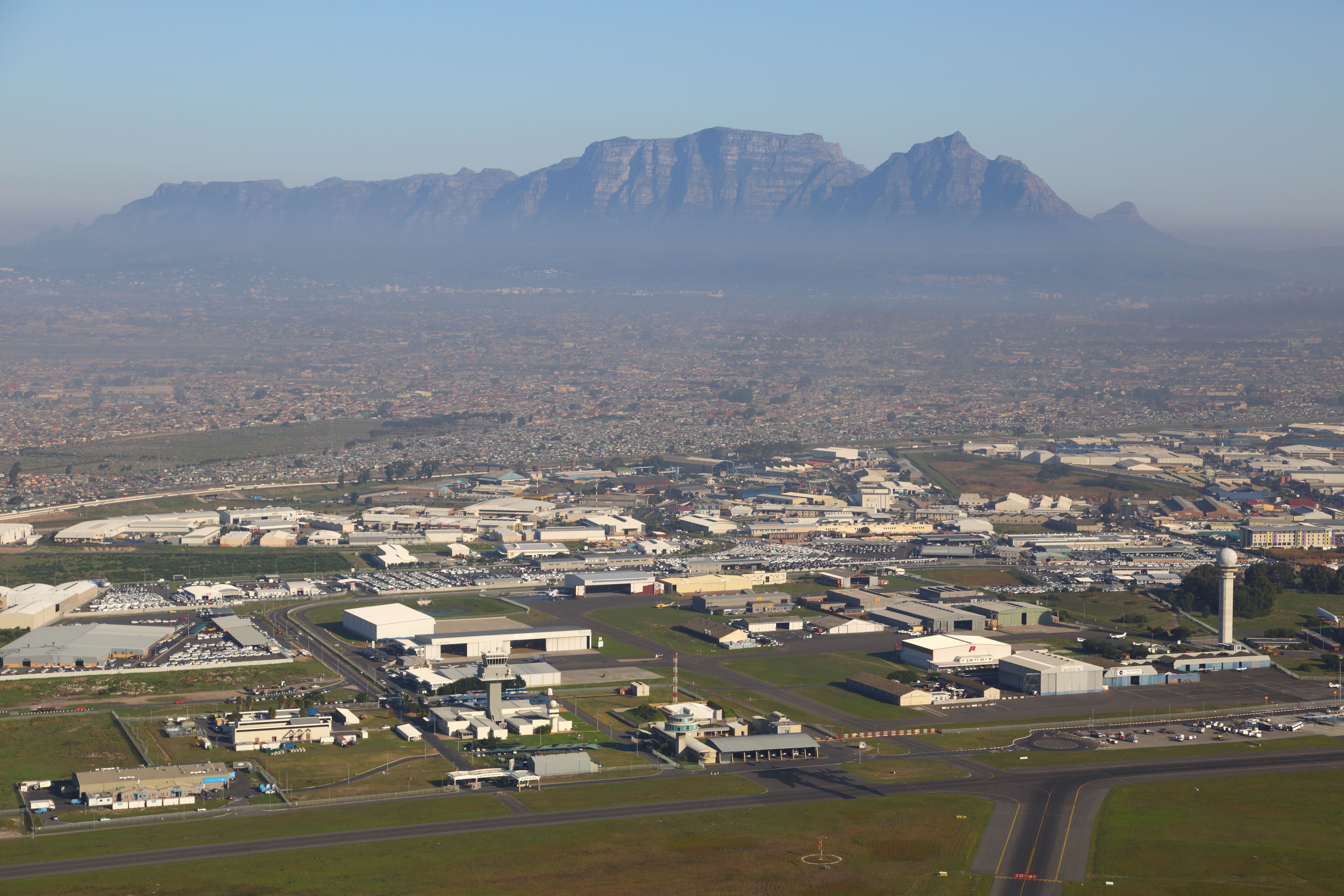 An aerial photo of Cape Town International Airport Runway and Terminal with Table Mountain in the background.