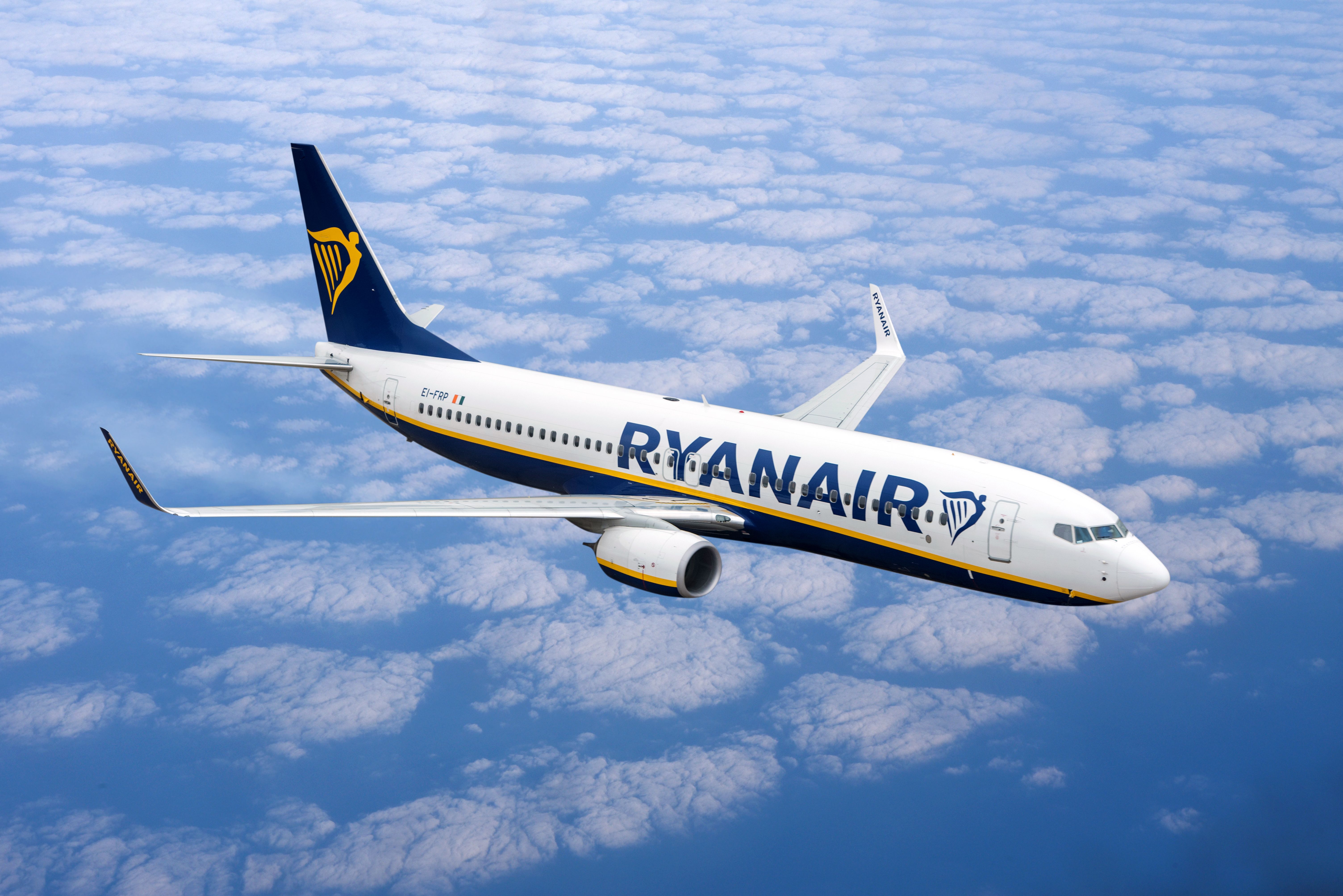 A Ryanair Boeing 737-800 flying above the clouds.