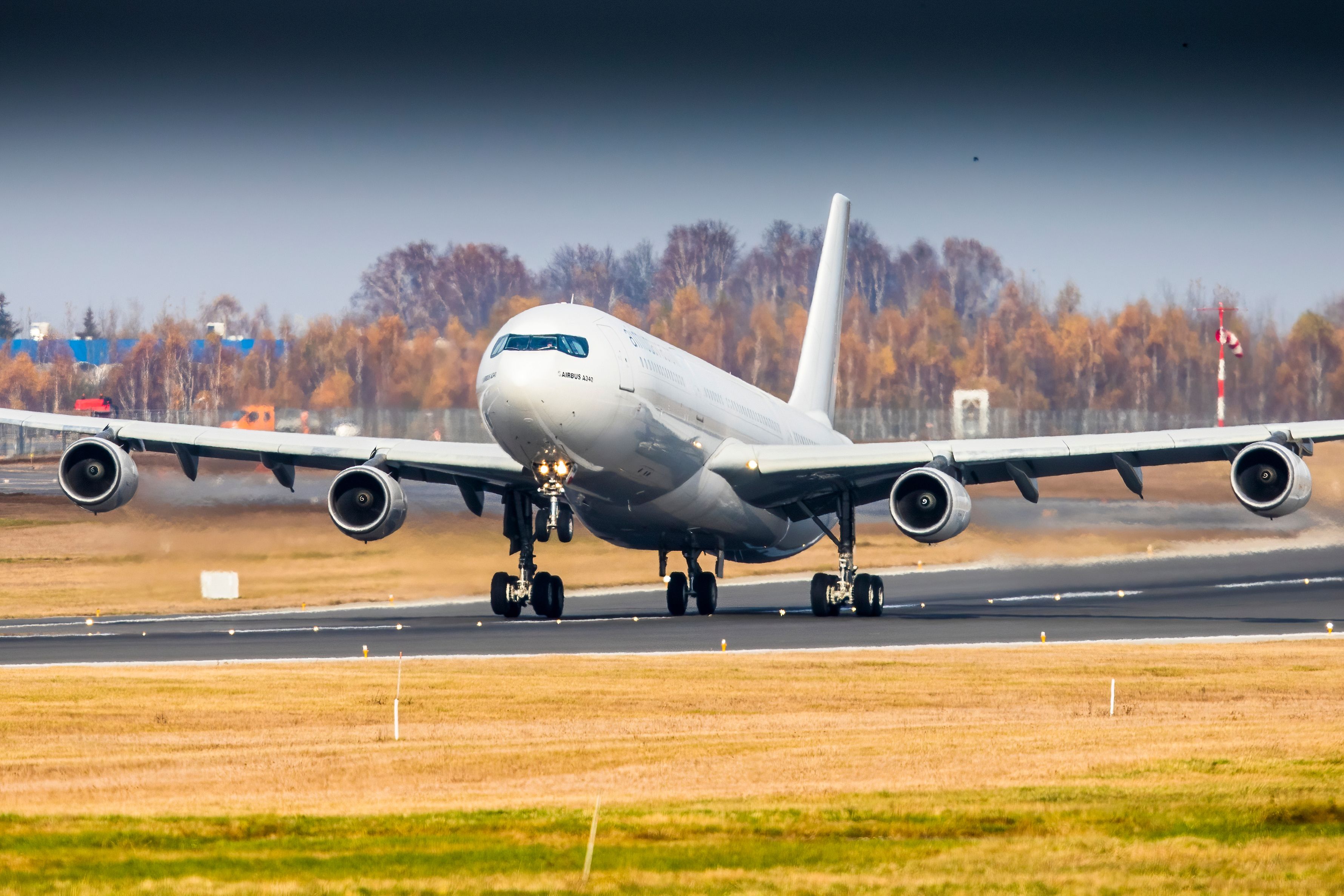 A White Airbus A340-300 Taking Off.