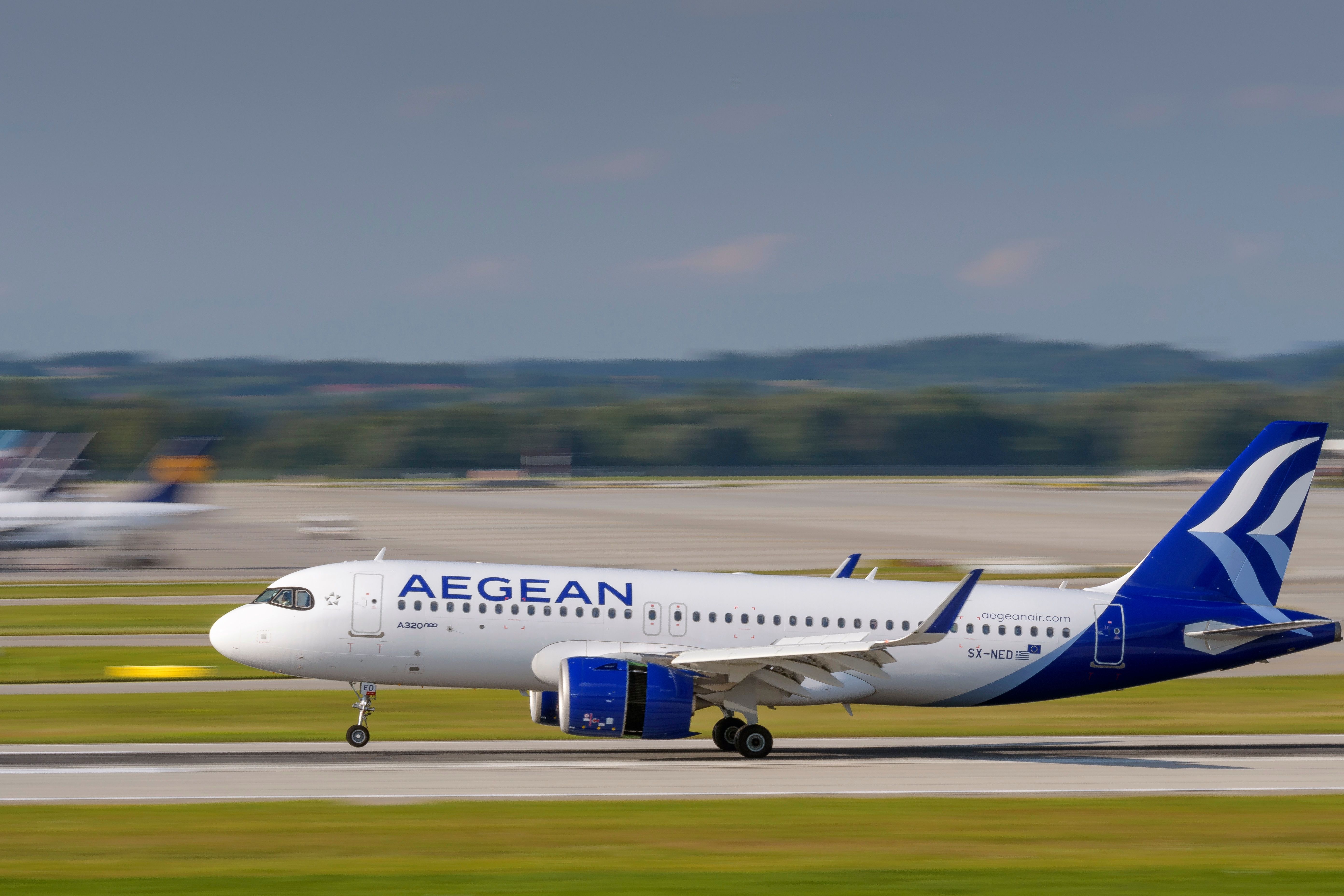 An Aegean Airlines Airbus A320-271N with the aircraft registration SX-NED is landing on the southern runway 26L of the Munich Airport MUC