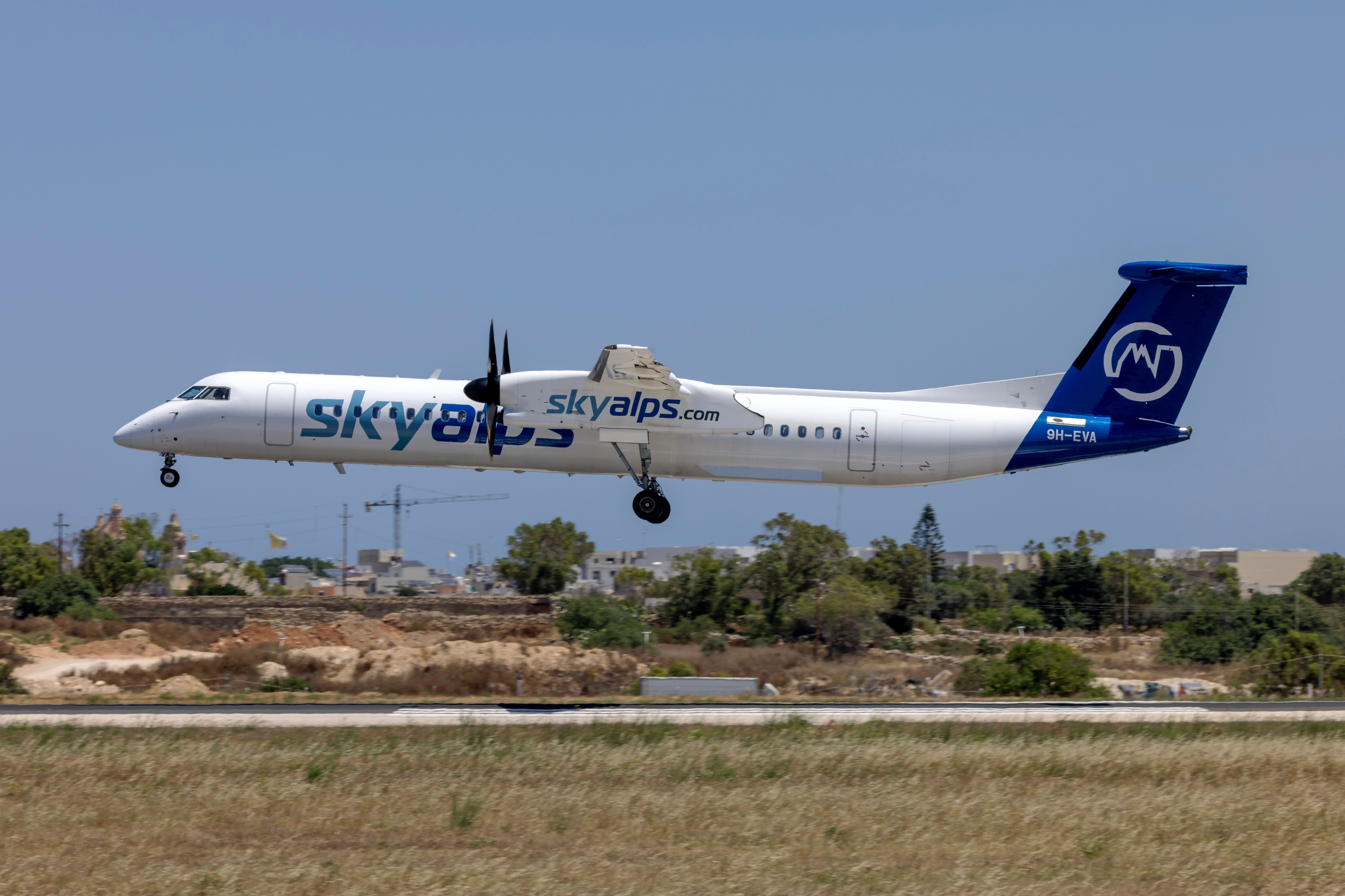 A SkyAlps Dash 8 about to land.