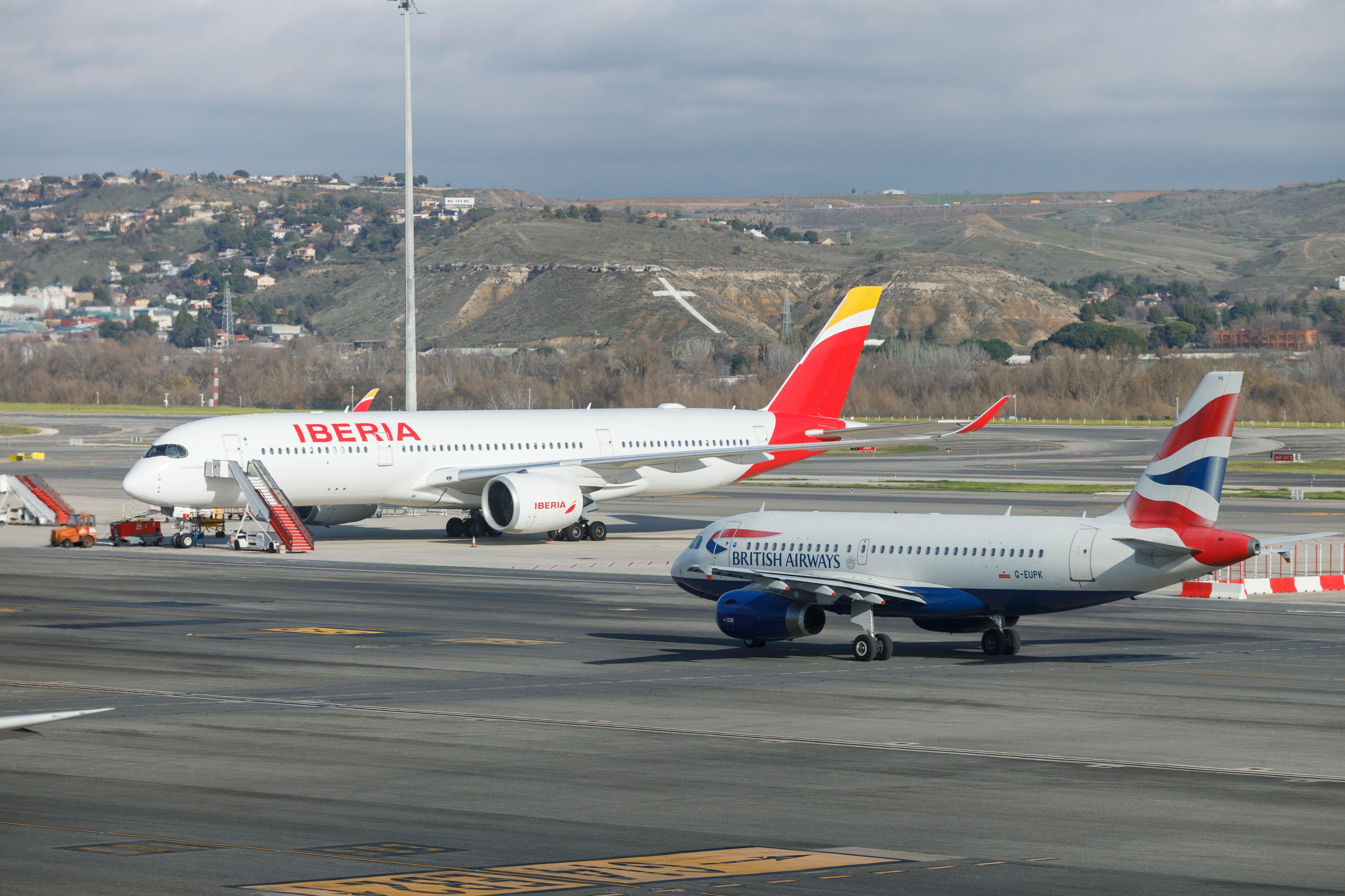 British Airways Airbus A319 Taxiing Past Iberia Airbus A350