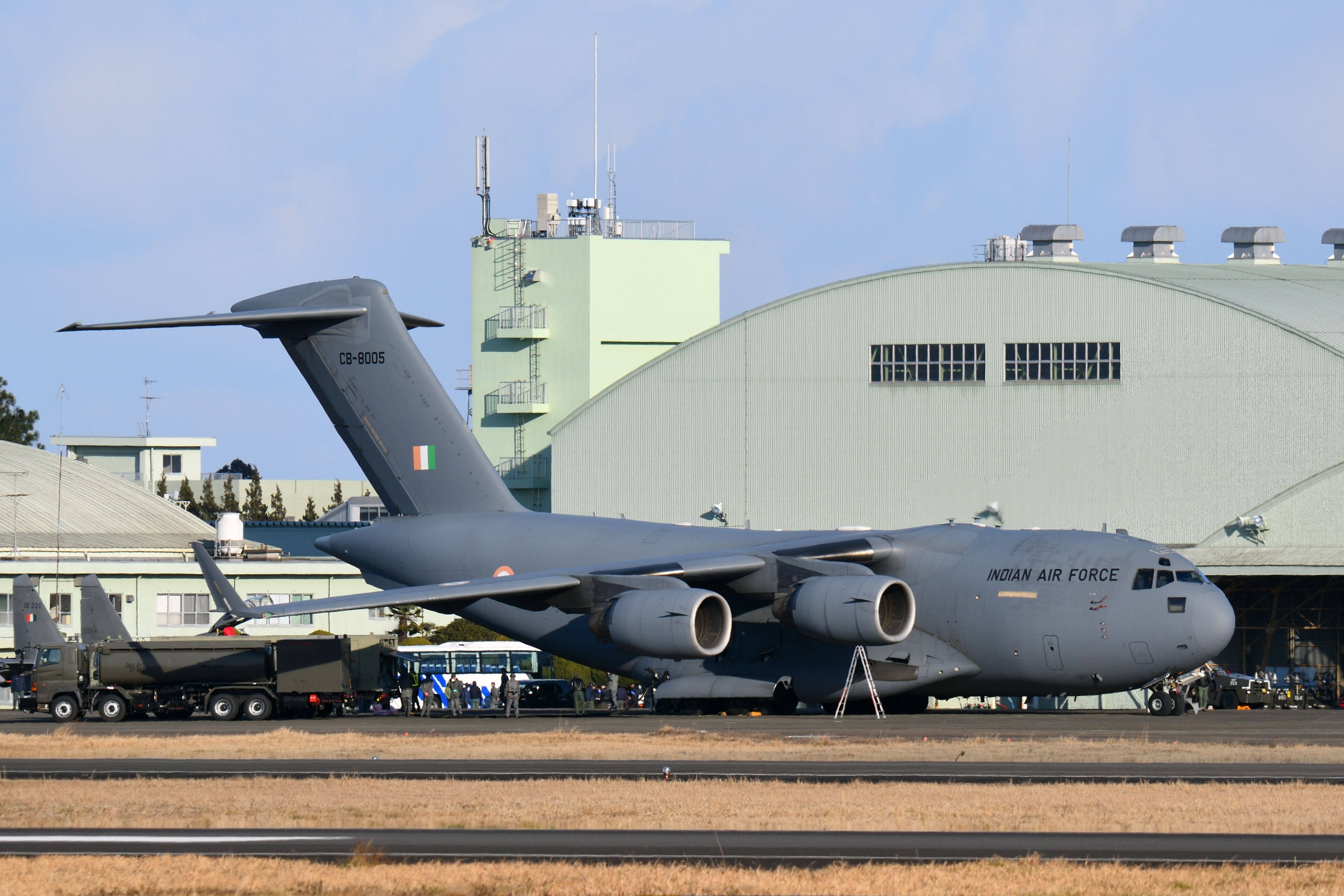 An India Air Force C-17 Globemaster III parked at an airfield.