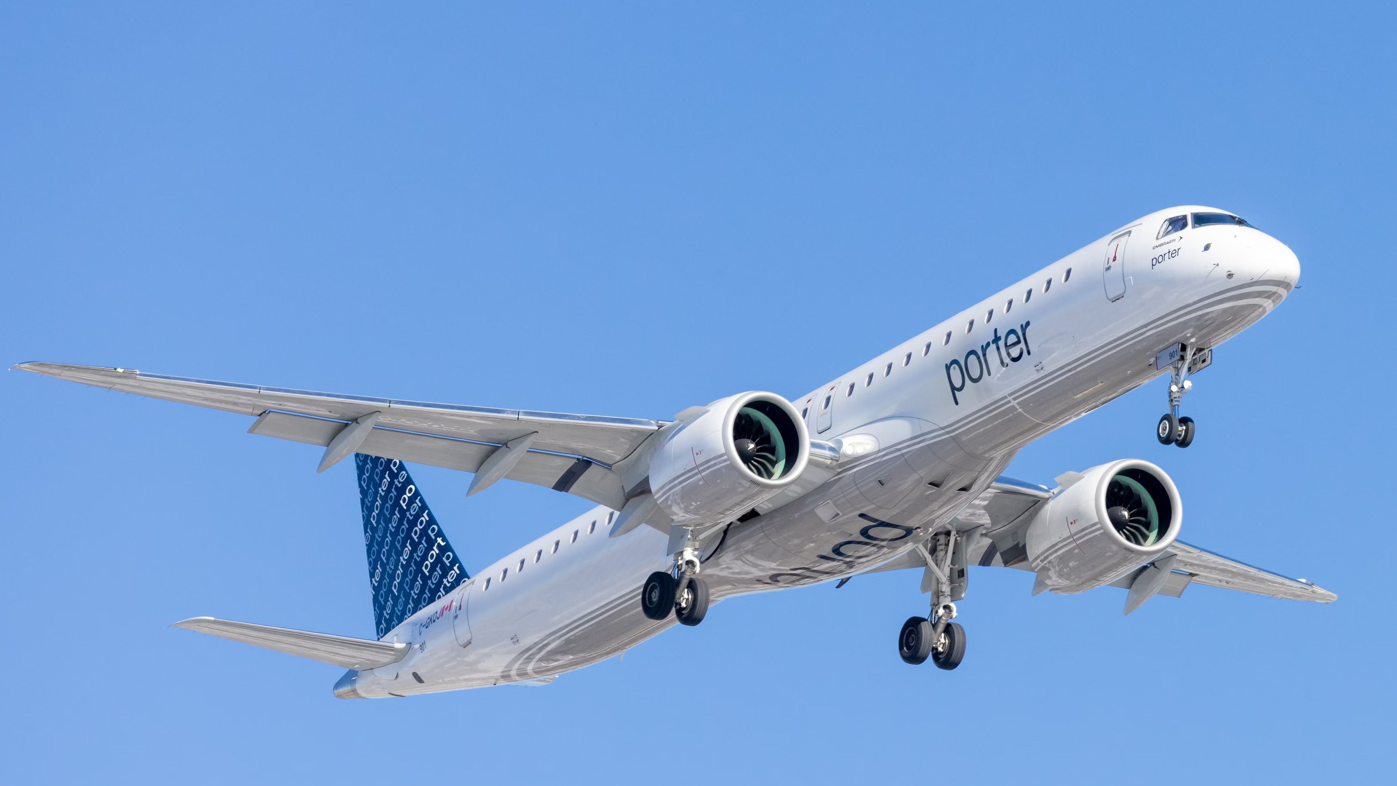 A Porter Airlines Embraer E195 flying in the sky.